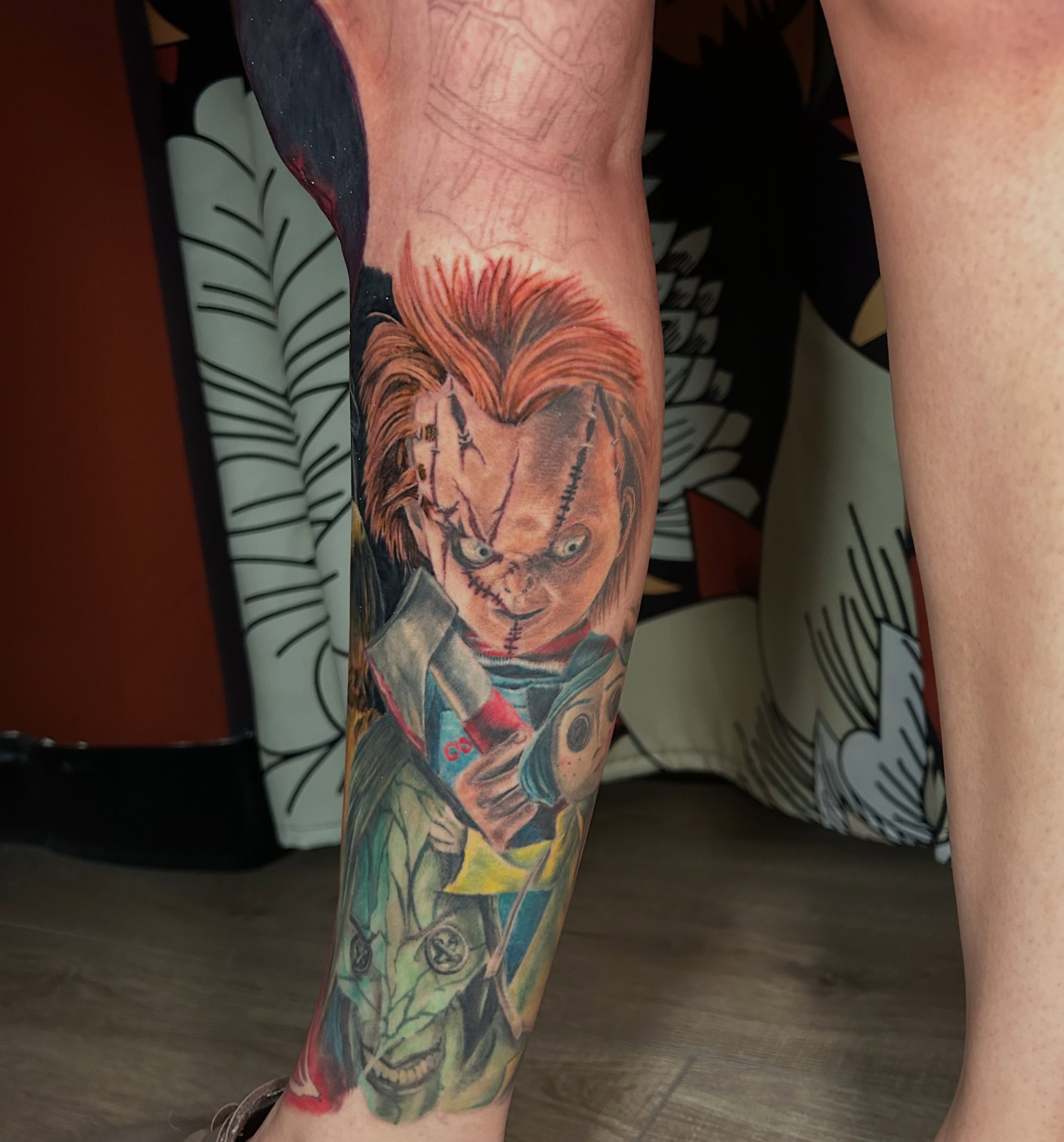 Chucky realism tattoo on the calf by Paisley Diaz, Lombard, Illinois