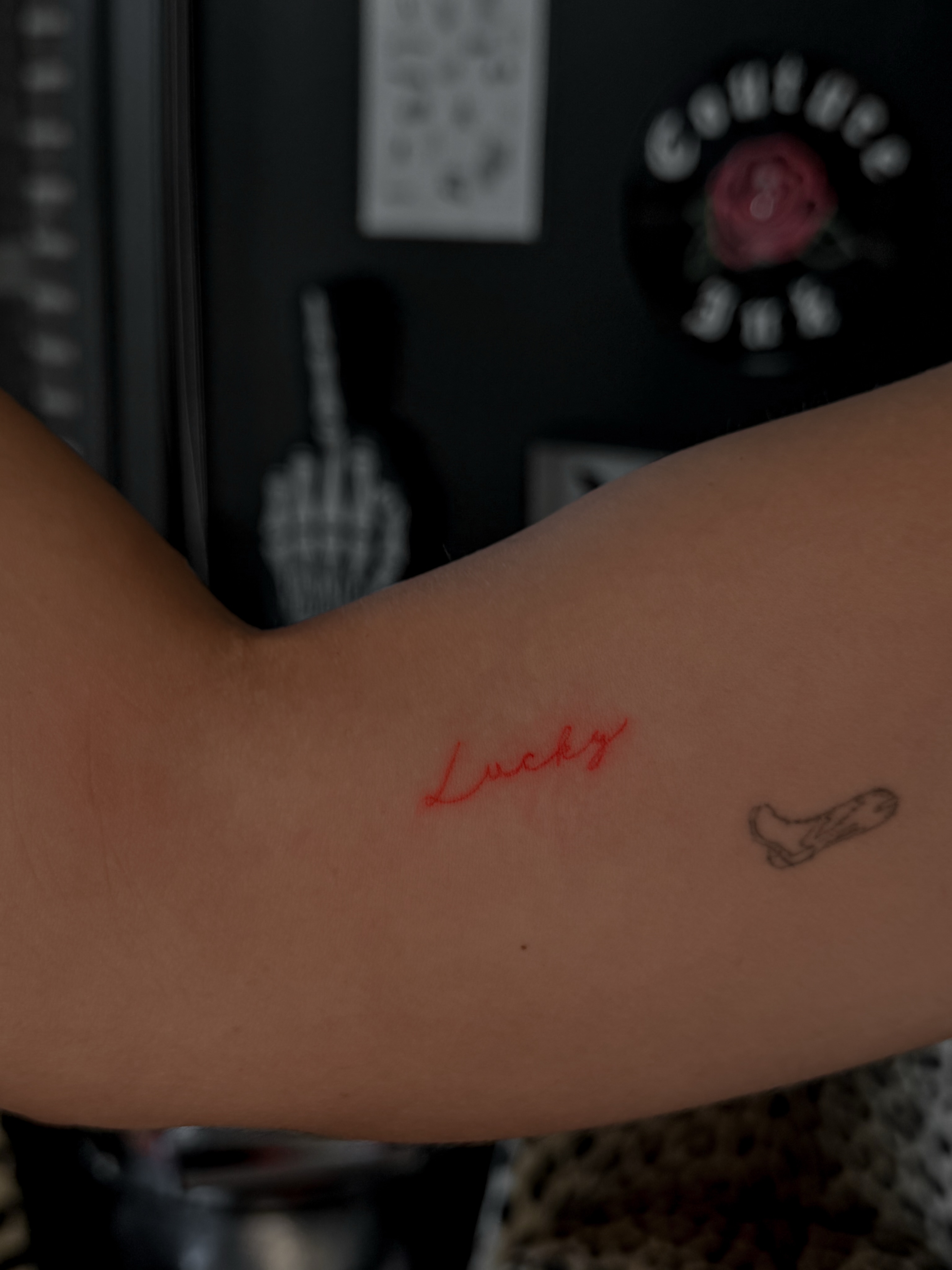 Lucky lettering script tattoo on the forearm by Ryleigh Benjamin