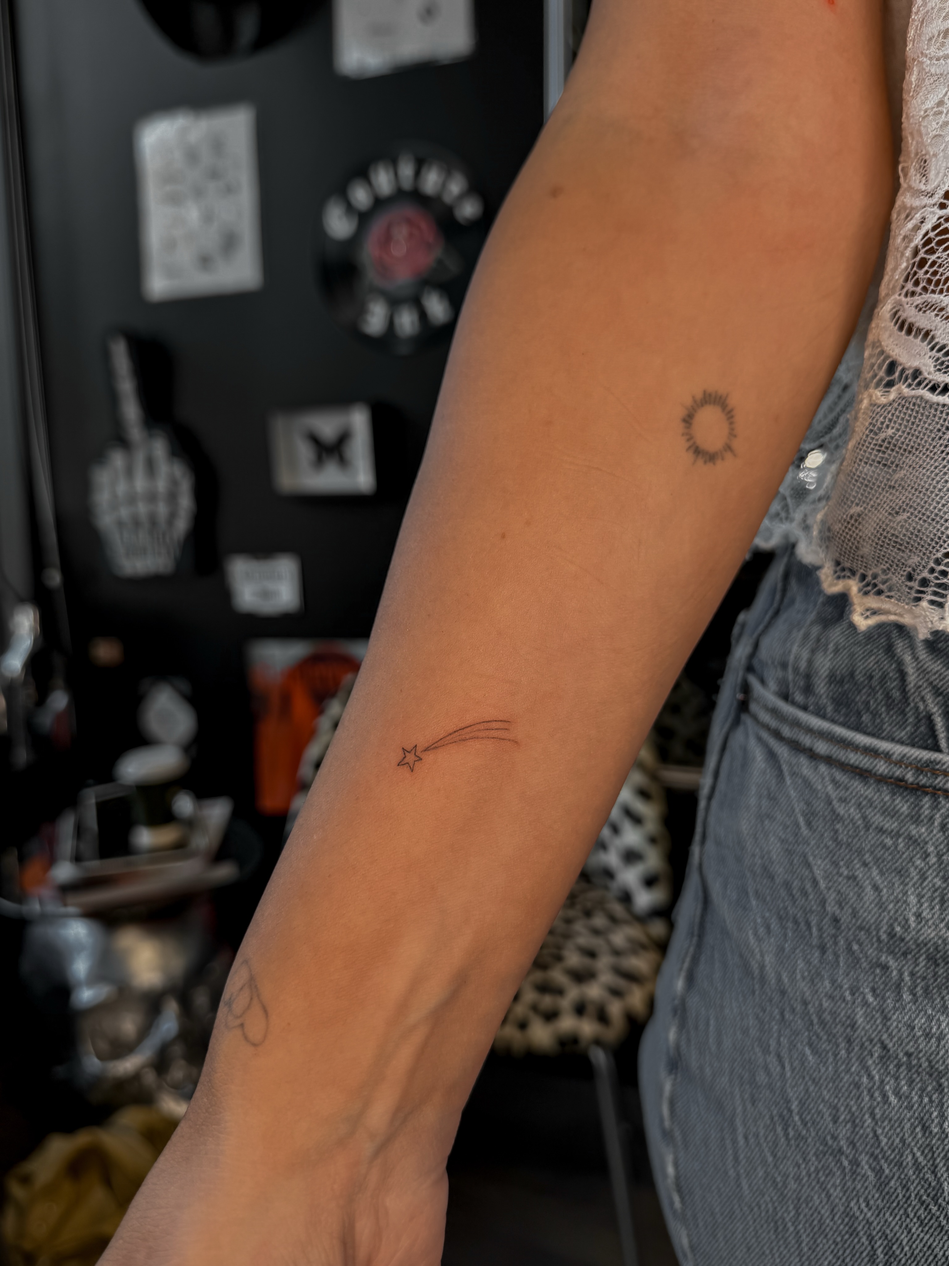Shooting star fine line tattoo on the forearm by Ryleigh Benjamin