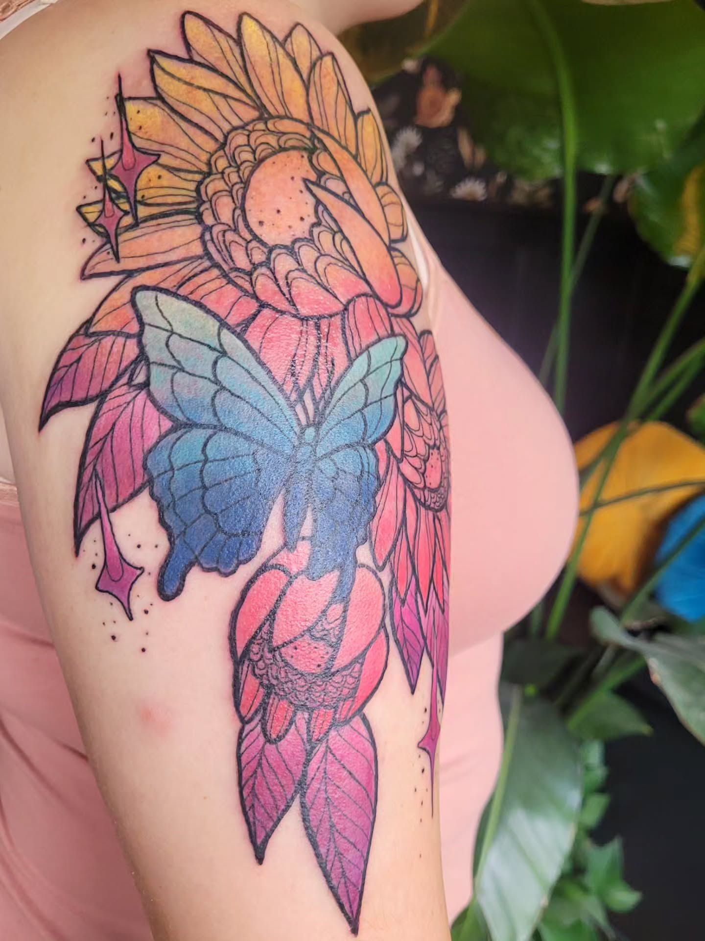 Sunflower and butterfly dotwork tattoo on the upper arm by Ashley Thomas, Midvale, Utah