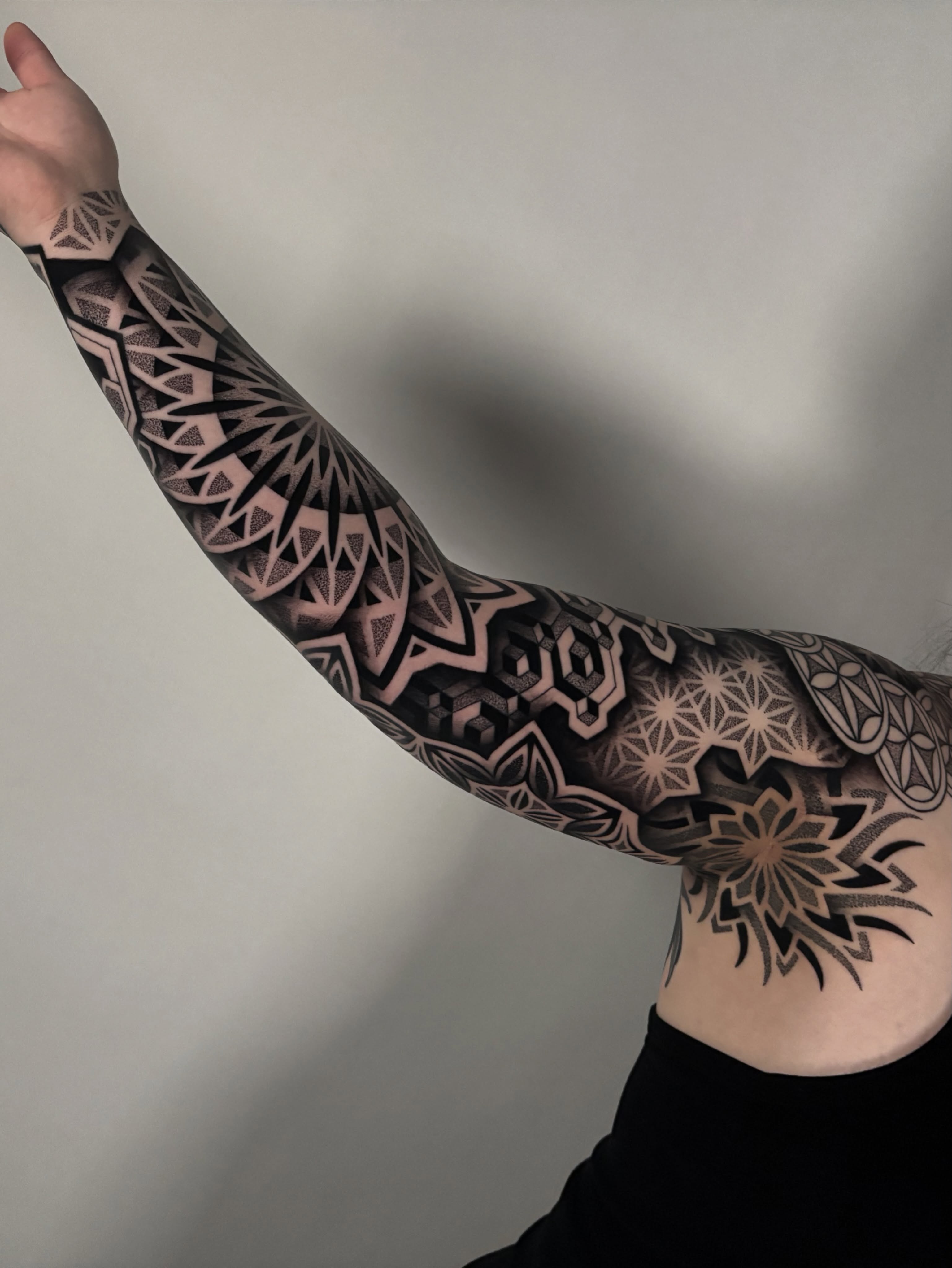 Geometric patterns geometric tattoo on the upper arm by Mitch Koch