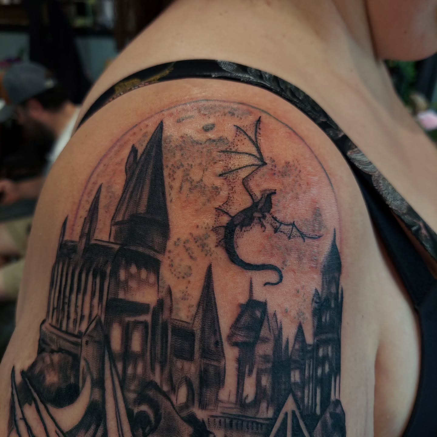 Hogwarts castle black and grey tattoo on the shoulder by Kari Rhoades, Marion, Iowa