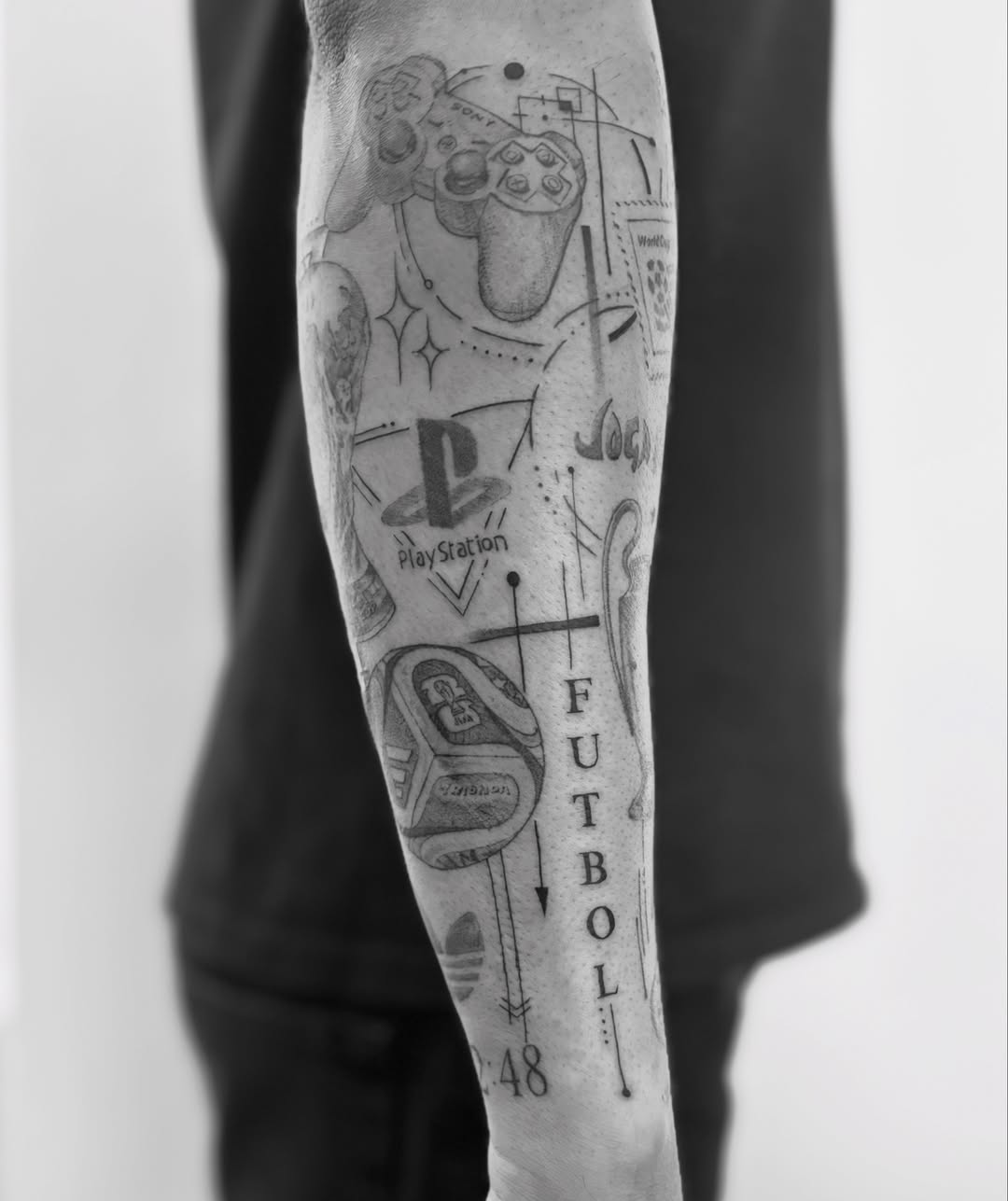 Video game controller and PlayStation logo geometric tattoo on the forearm by @secretlinetattoo