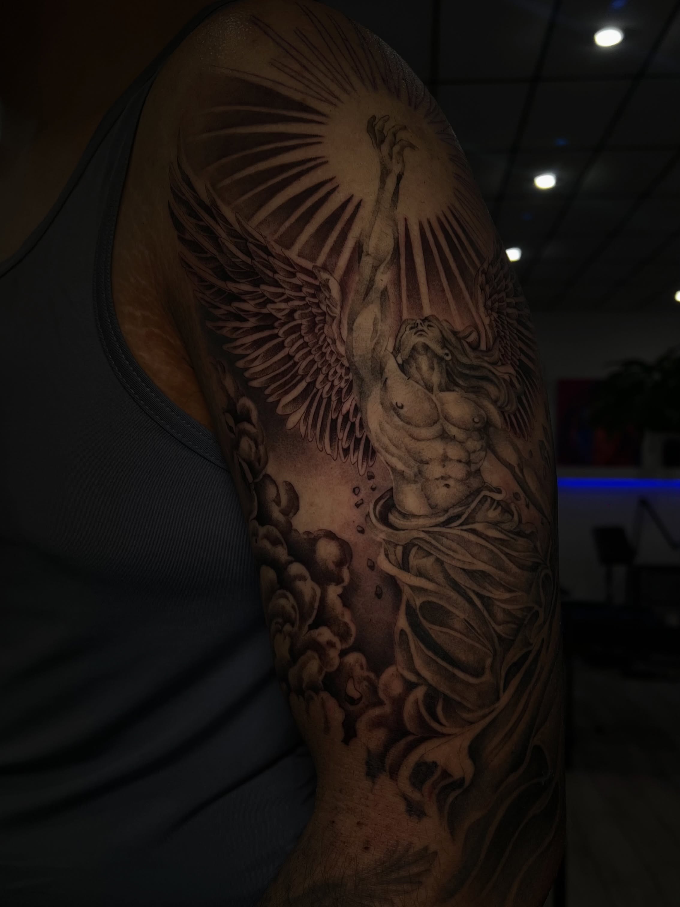 Angelic figure realism tattoo on the upper arm by Espi