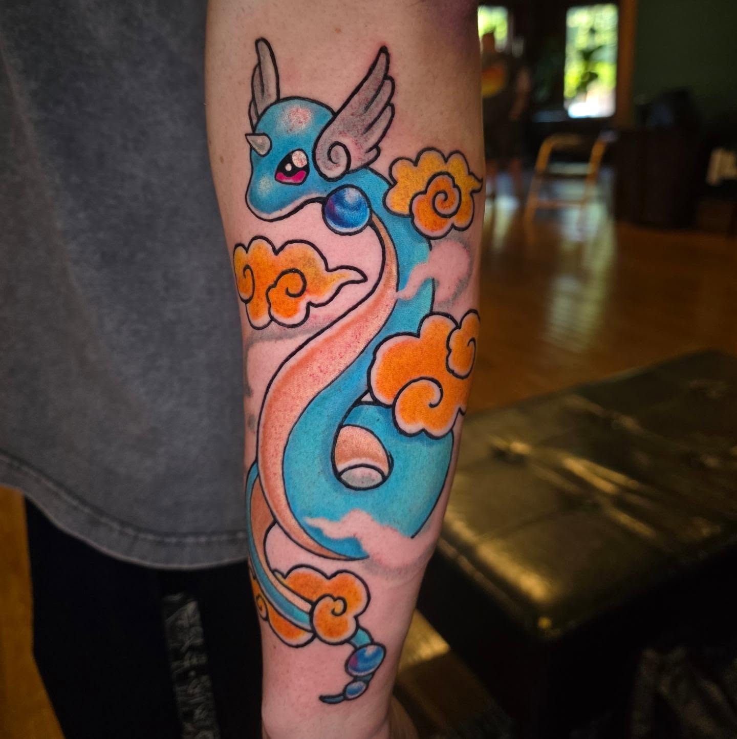 Dragon new school tattoo on the forearm by Kayla Williams