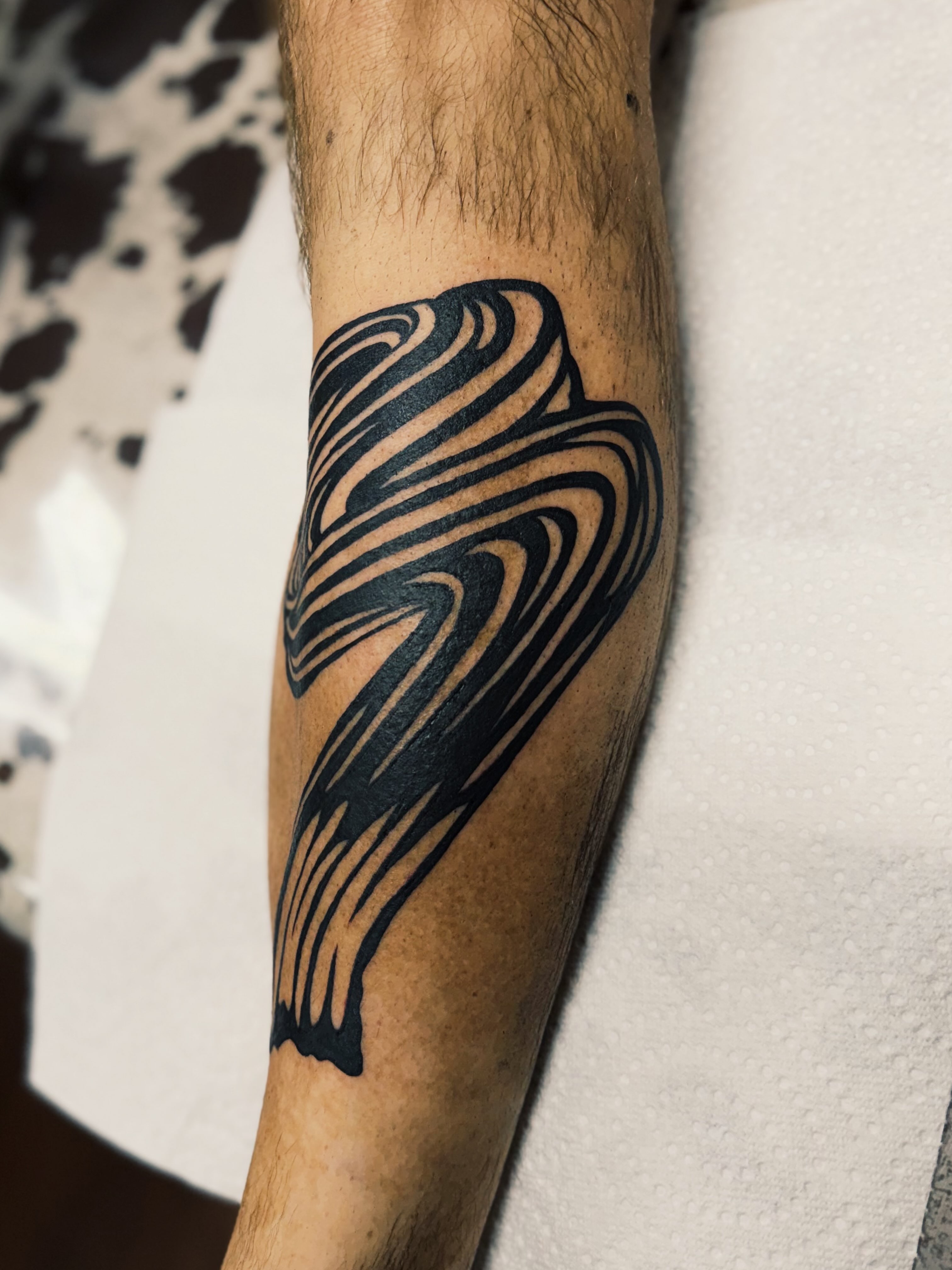 Abstract wave geometric tattoo on the forearm by @amandahowtattoo
