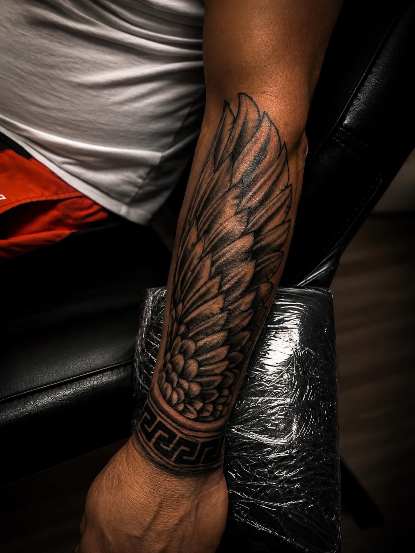 Wing realism tattoo on the forearm by Rico Rosario