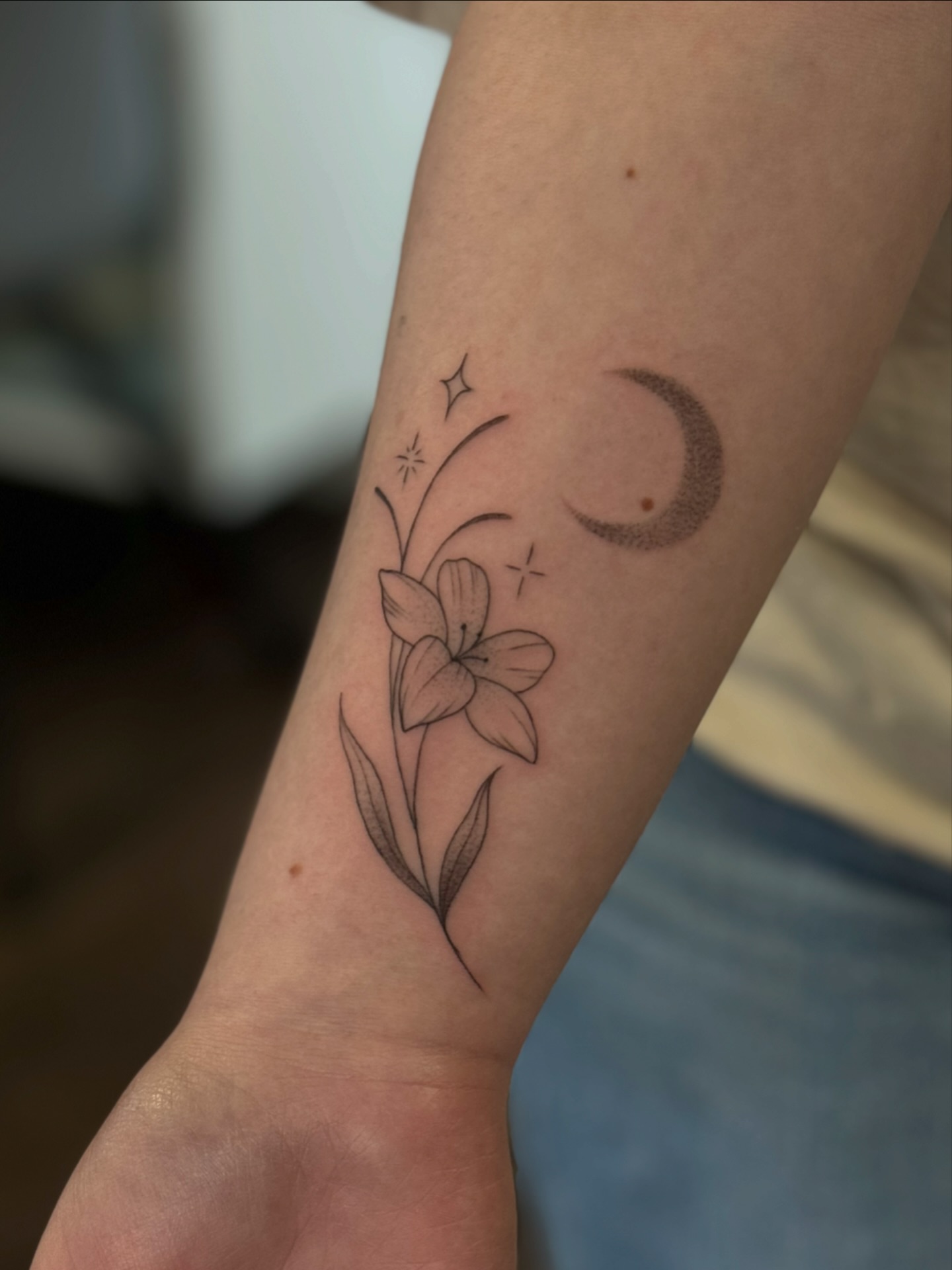 Lily and crescent moon fine line tattoo on the forearm by ꧁꧁Hayley꧂꧂