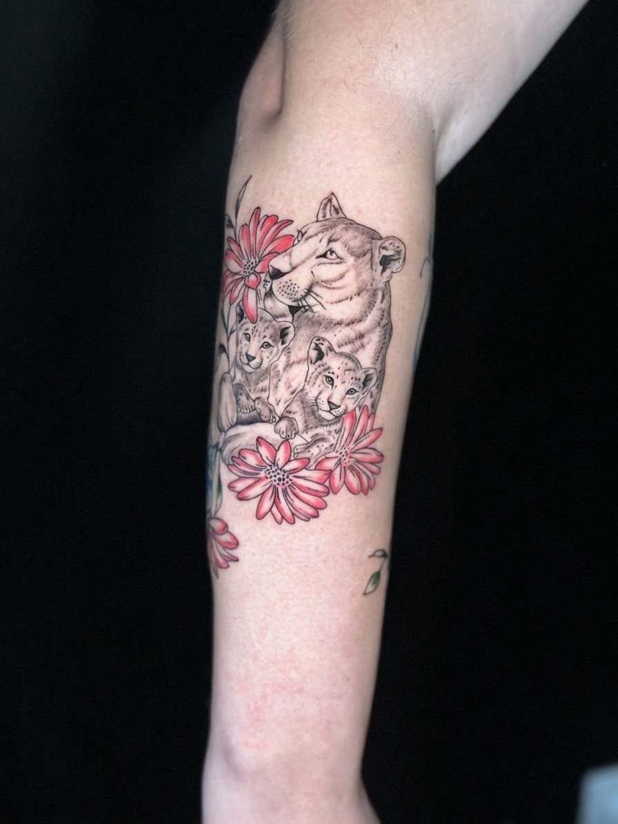 Lion family with flowers realism tattoo on the forearm by AJ