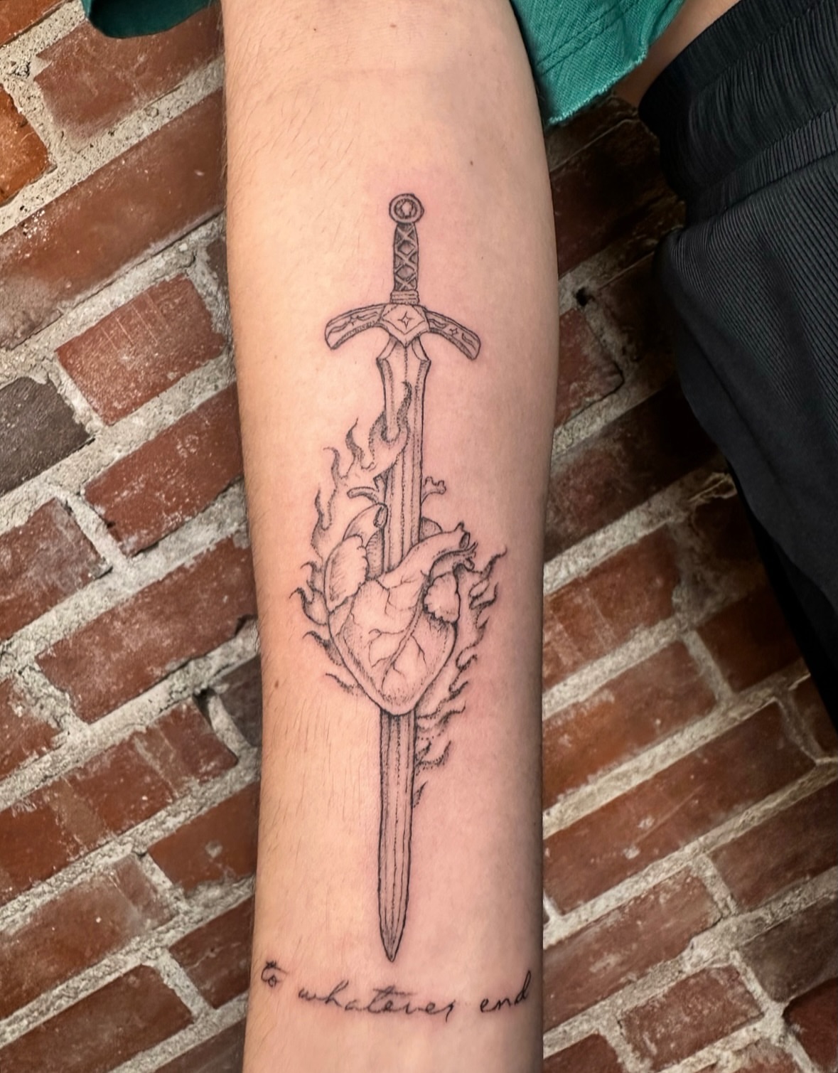 Heart and sword realism tattoo on the forearm by kenzie hunter