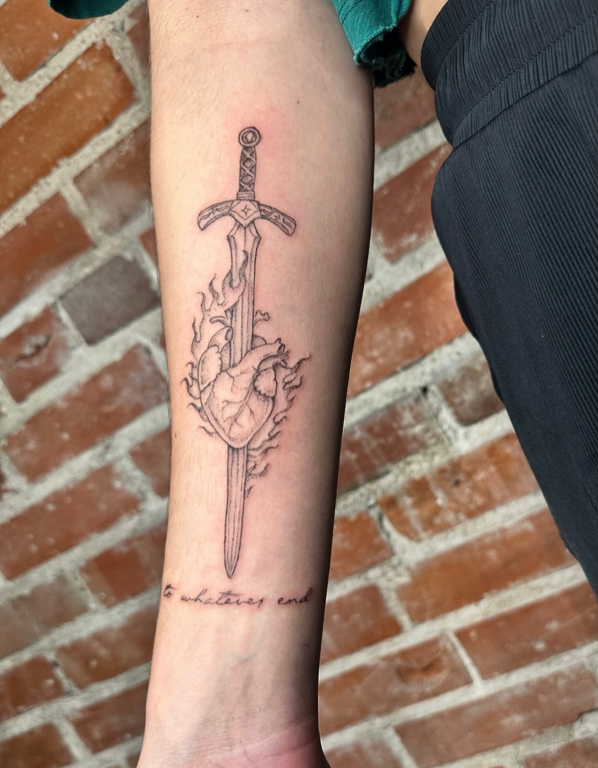 Heart and sword realism tattoo on the forearm by kenzie hunter