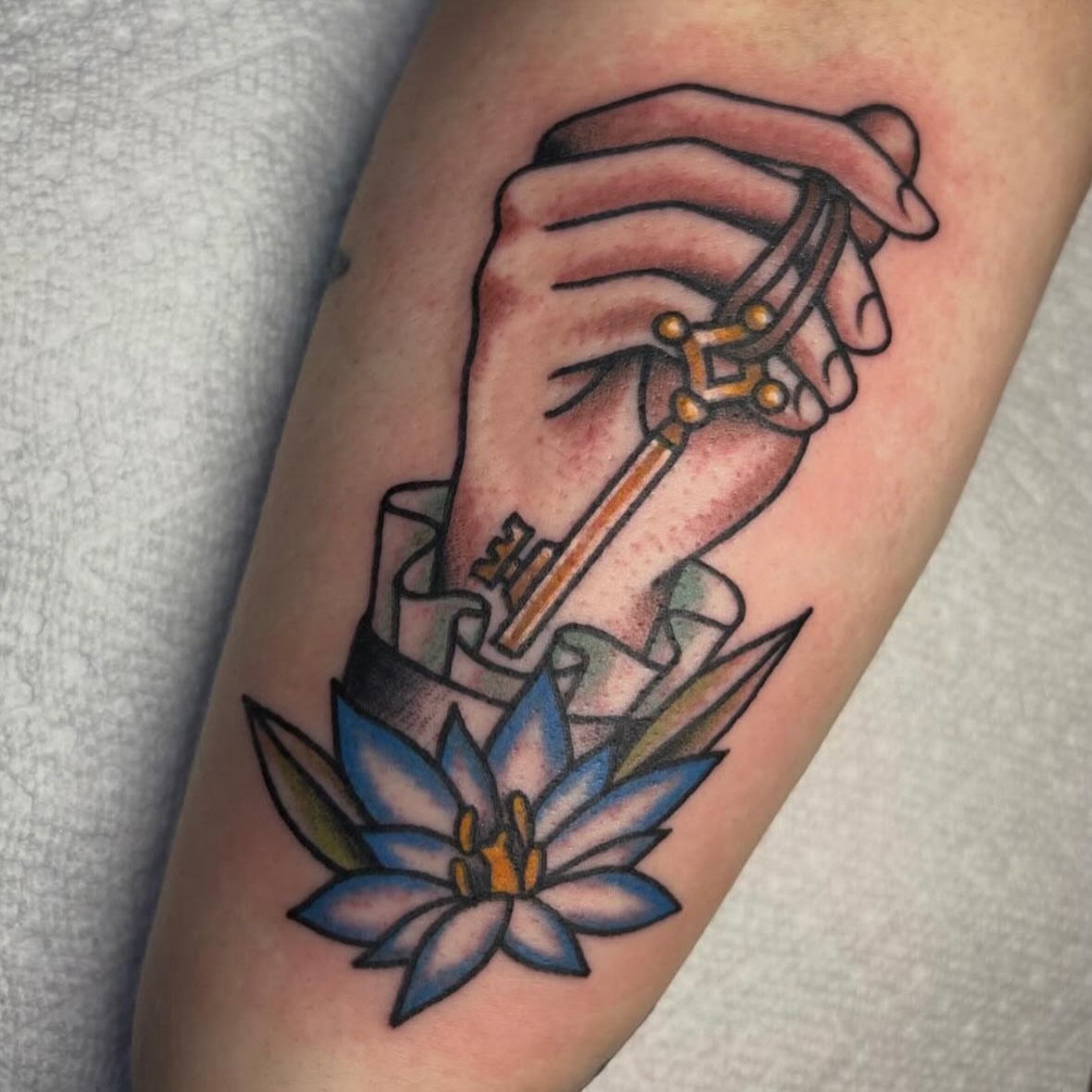 Key and flower American traditional tattoo on the forearm by ππππππππ