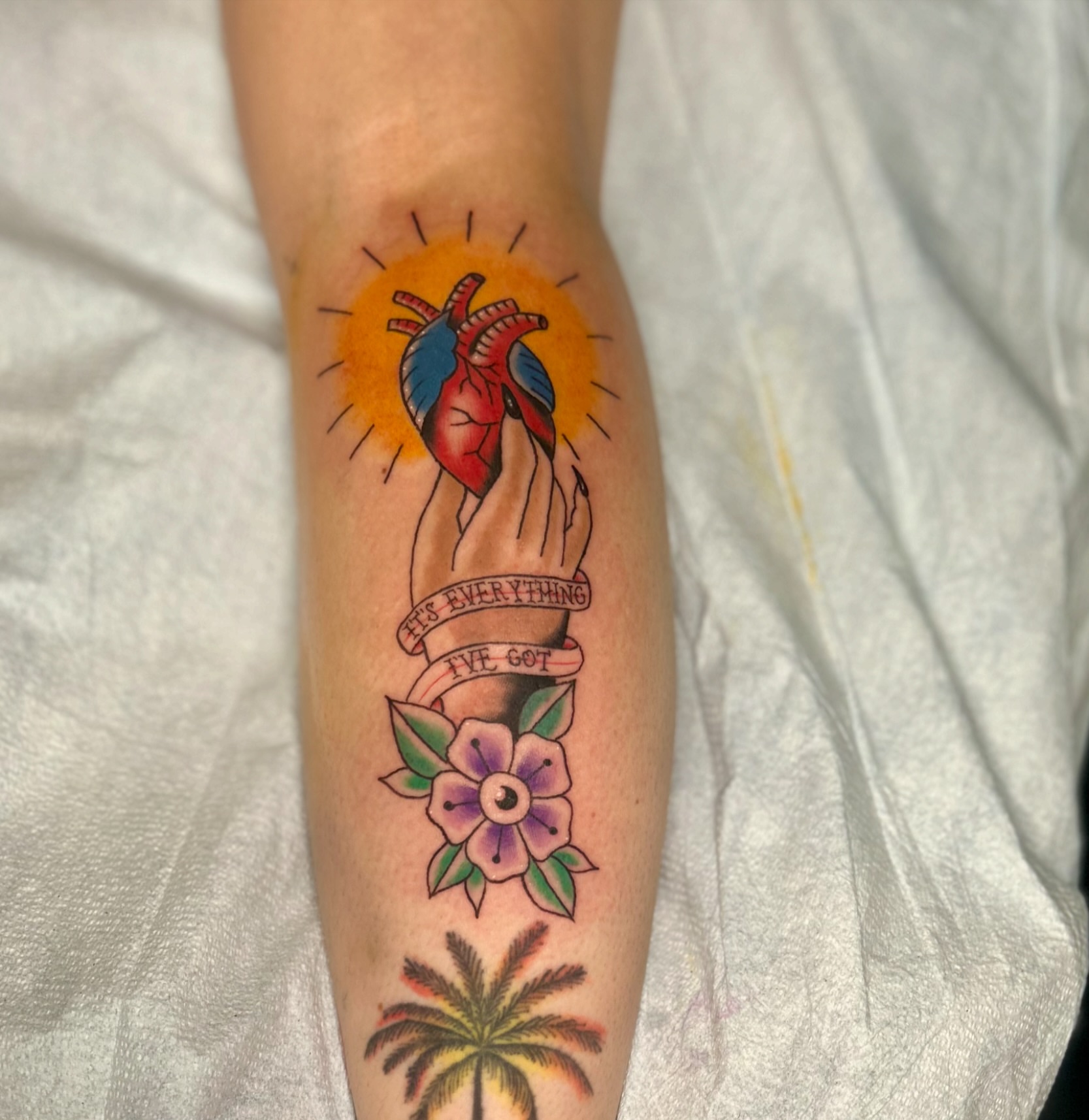 Heart and hand American traditional tattoo on the forearm by Tori Magill