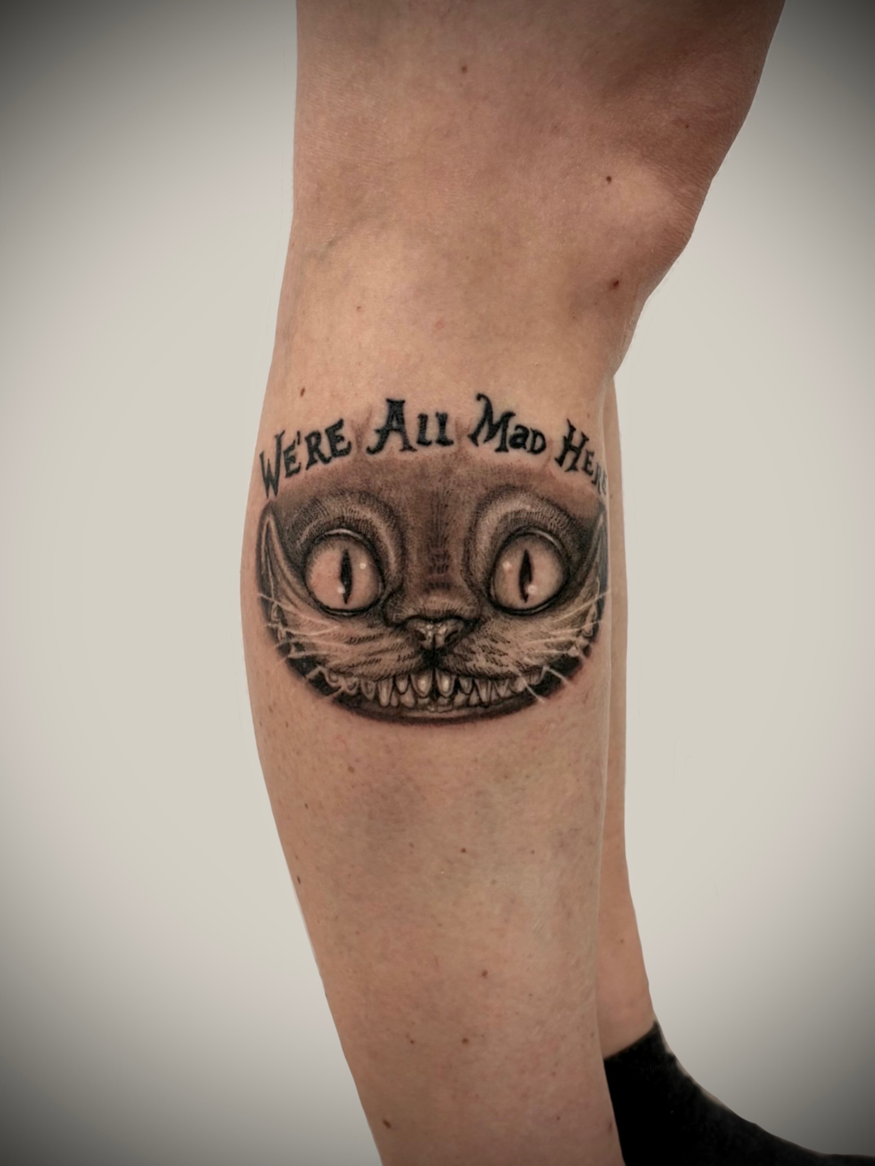 Cat face black and grey tattoo on the forearm by Deborah