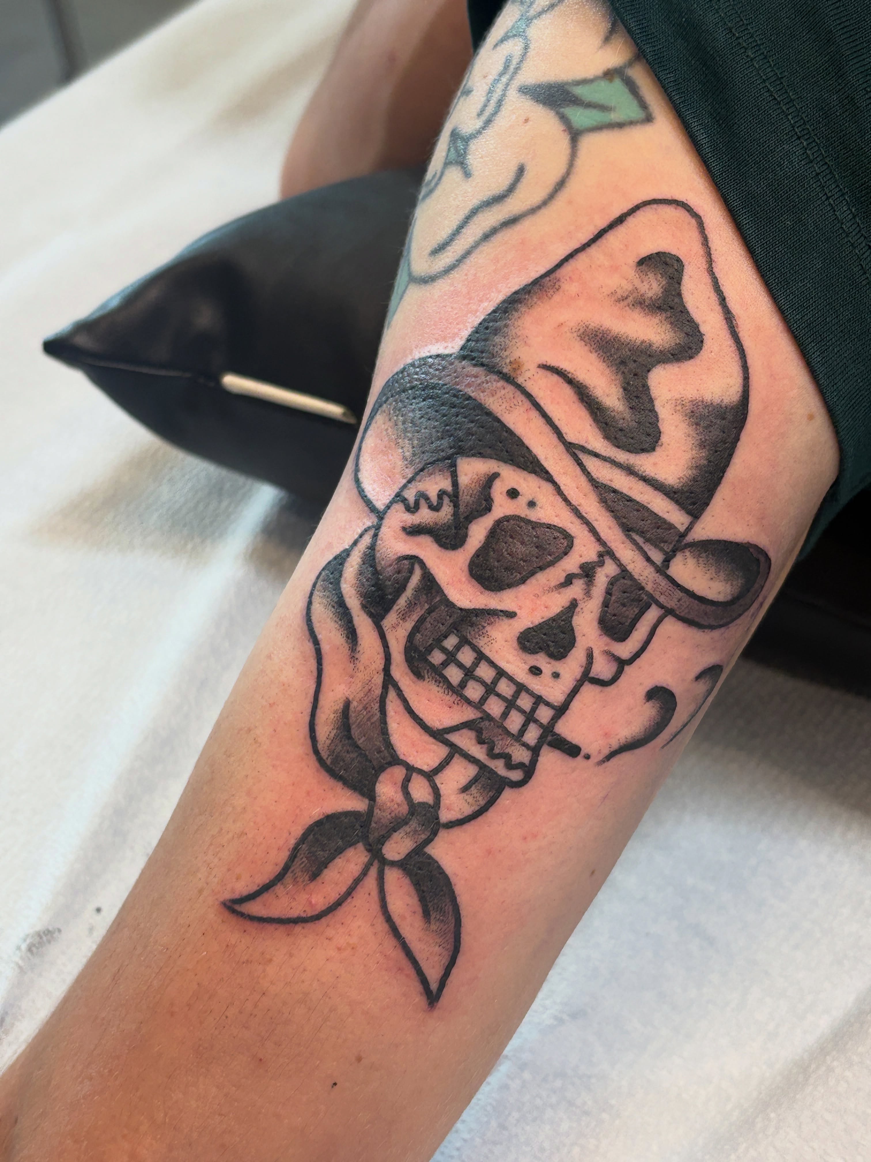 Skull wearing bandana American traditional tattoo on the forearm by Sammy Tattoo, Austin, Texas