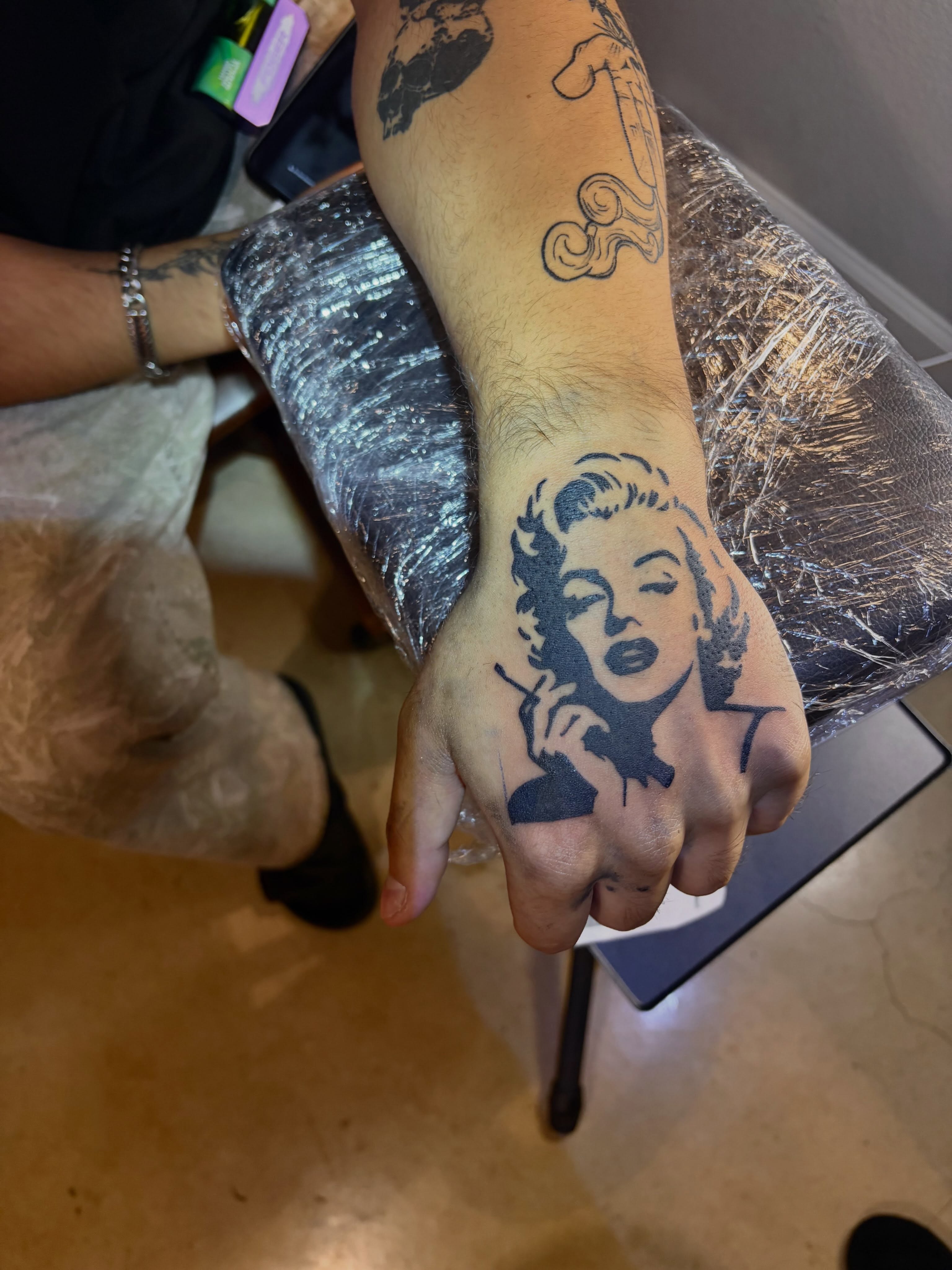 Marilyn monroe black and grey tattoo on the hand by blastedbybk