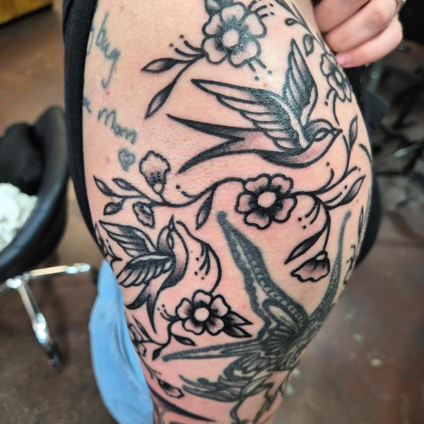 Birds and flowers American traditional tattoo on the upper arm by Taylor Popkins