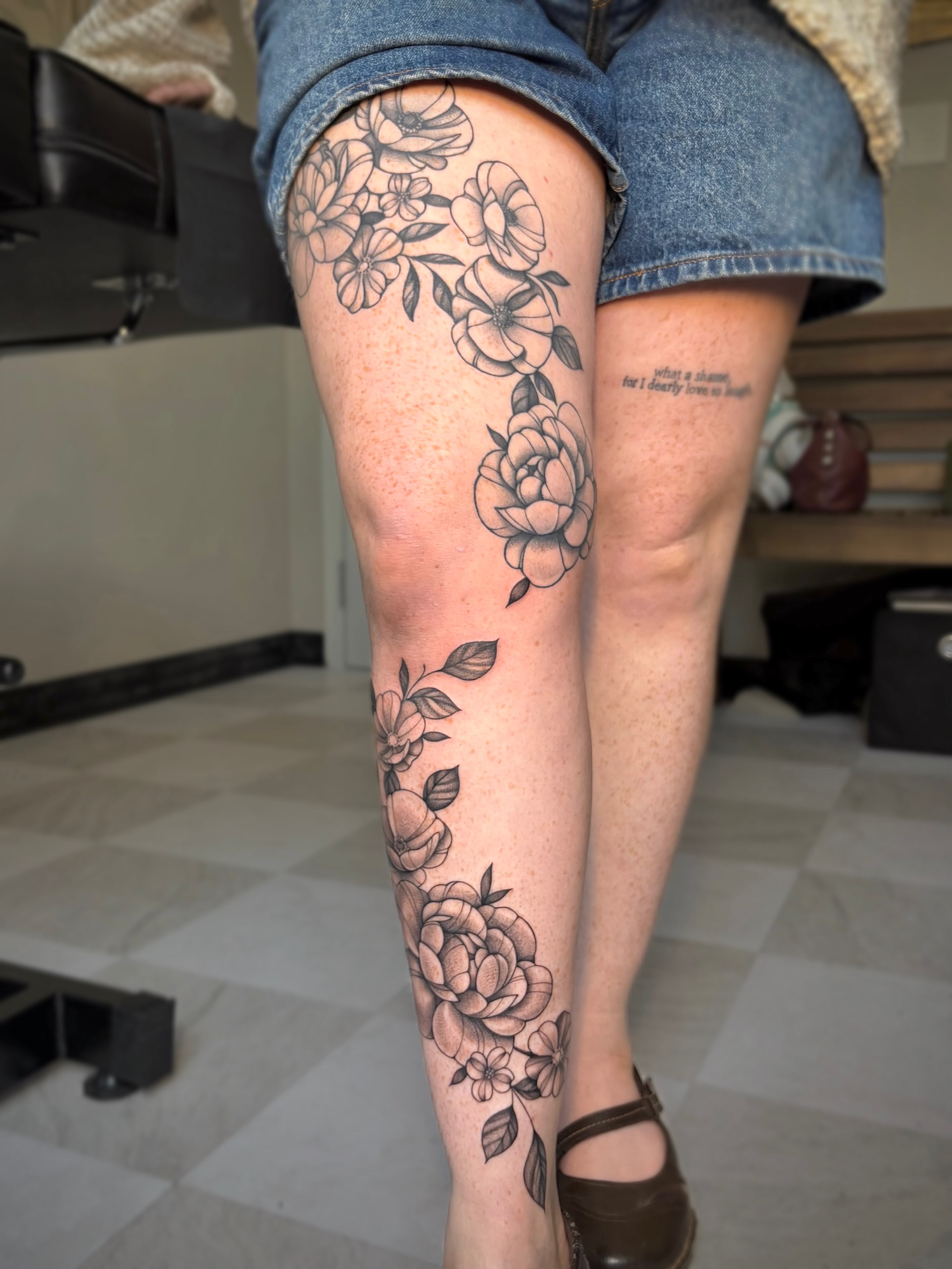 Floral bouquet black and grey tattoo on the calf by kuna ink