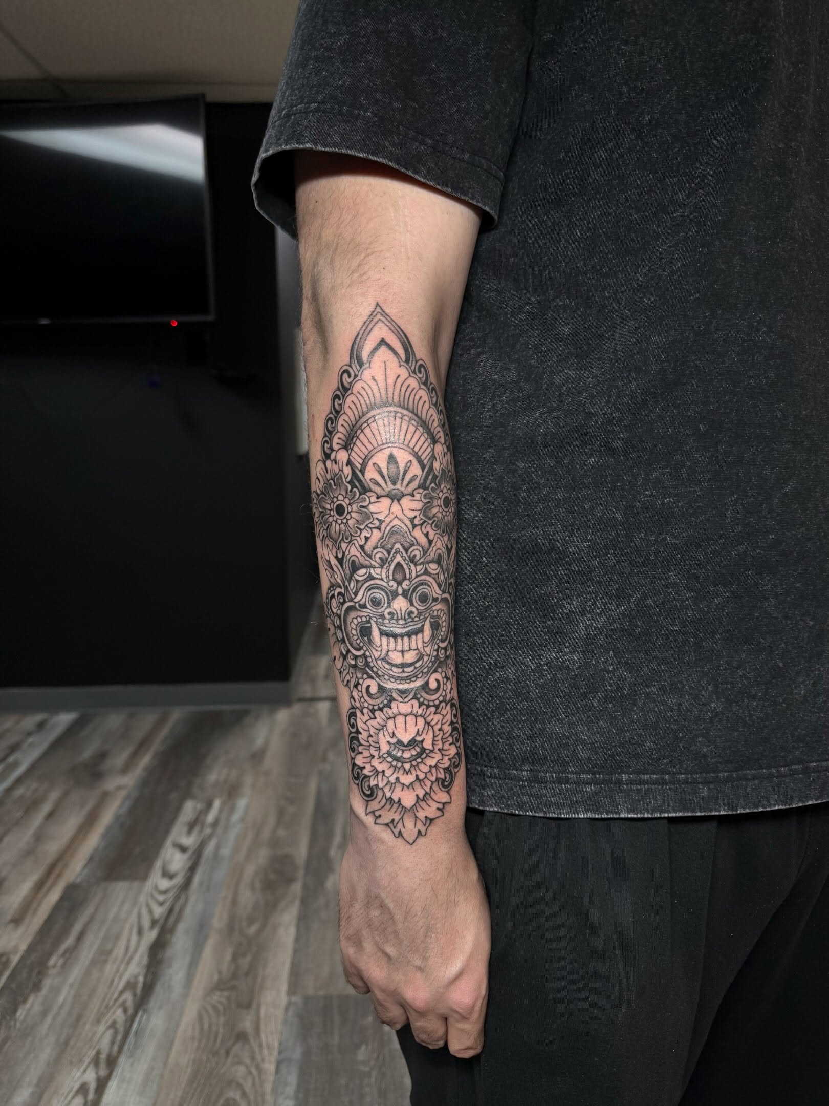 Barong mask black and grey tattoo on the forearm by ✶ teryn ✶, Akron, Ohio
