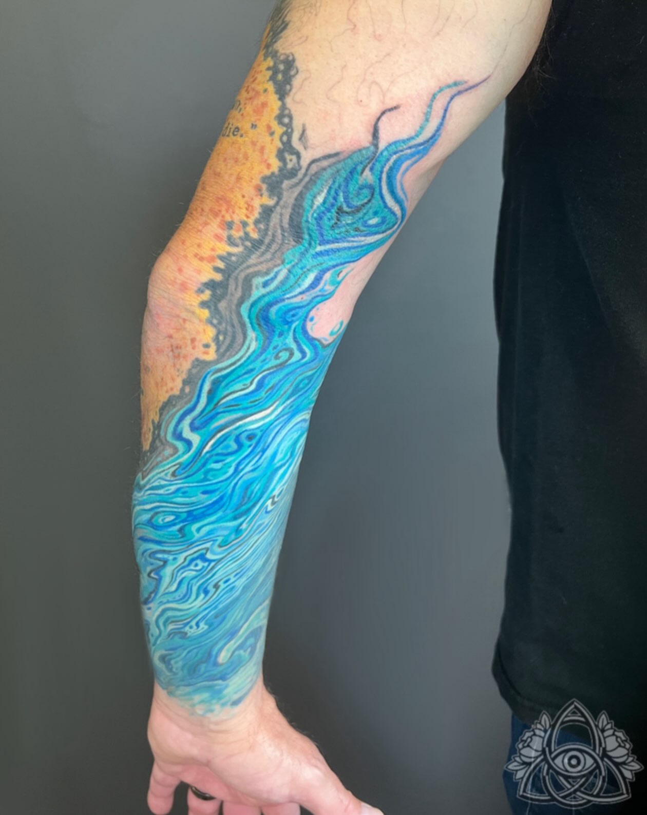 Watercolor wave watercolor tattoo on the forearm by Michael - Tattoo Garden Everett, Everett, Washington