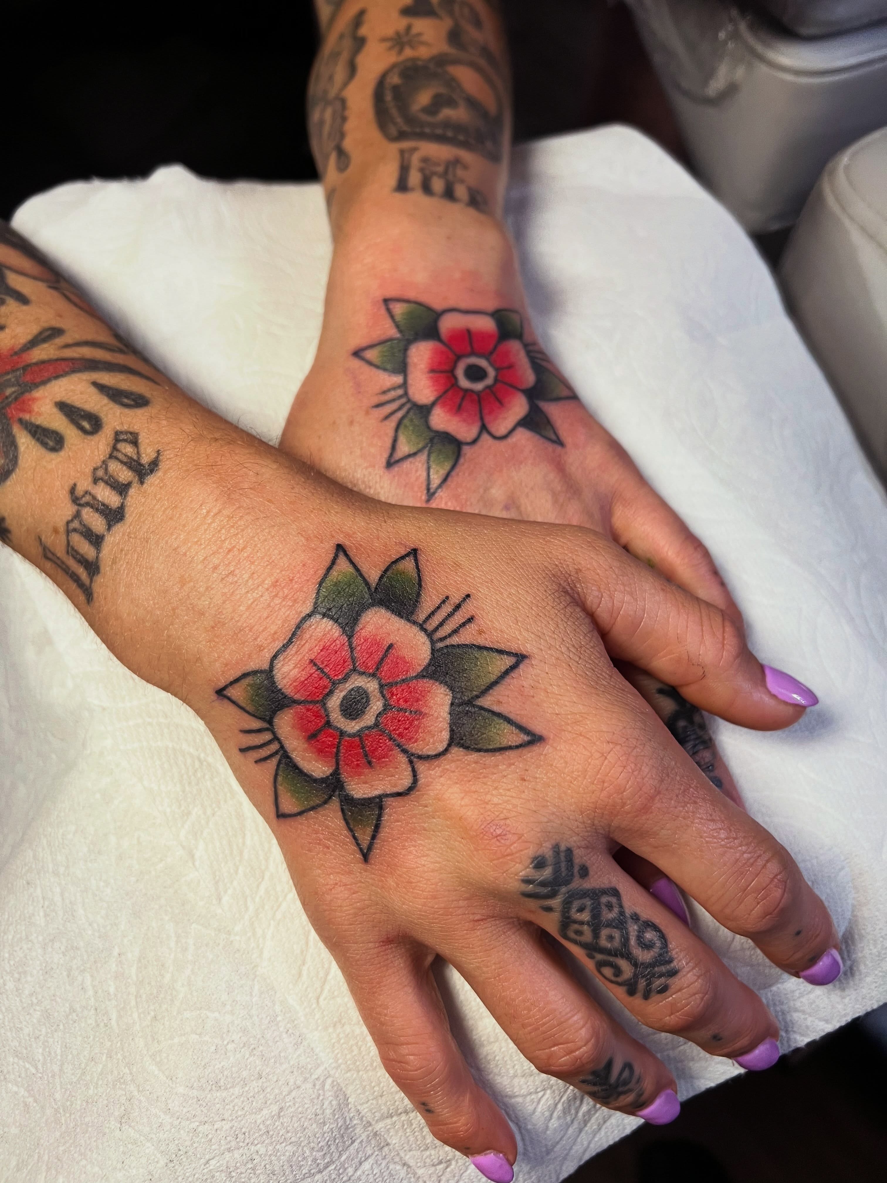 Flower American traditional tattoo on the hand by Samantha Citer