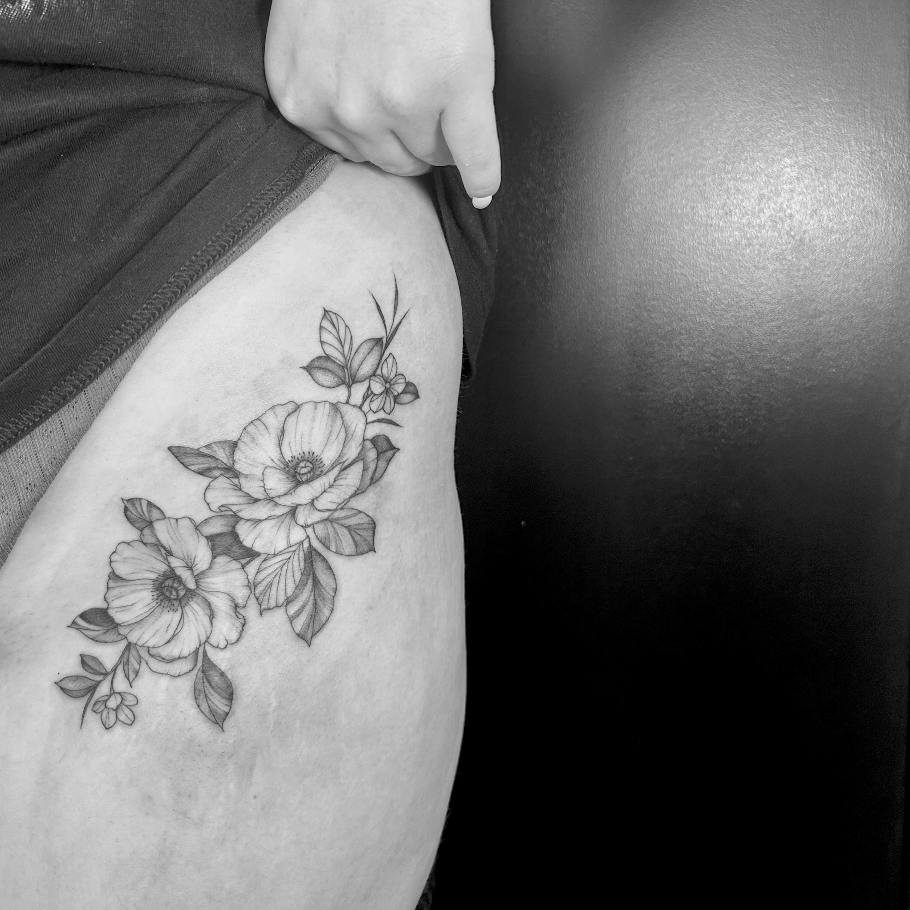Flowers black and grey tattoo on the thigh by L i v π Tattoo Artist. AMITY TATTOO