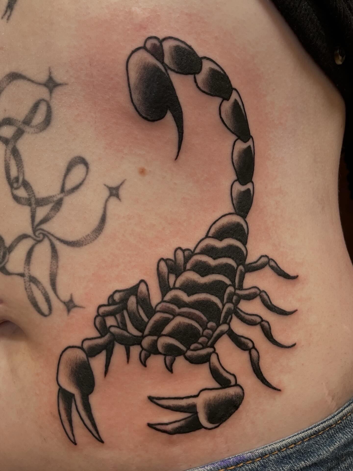 Scorpion black and grey tattoo on the ribs by Nick Wallin