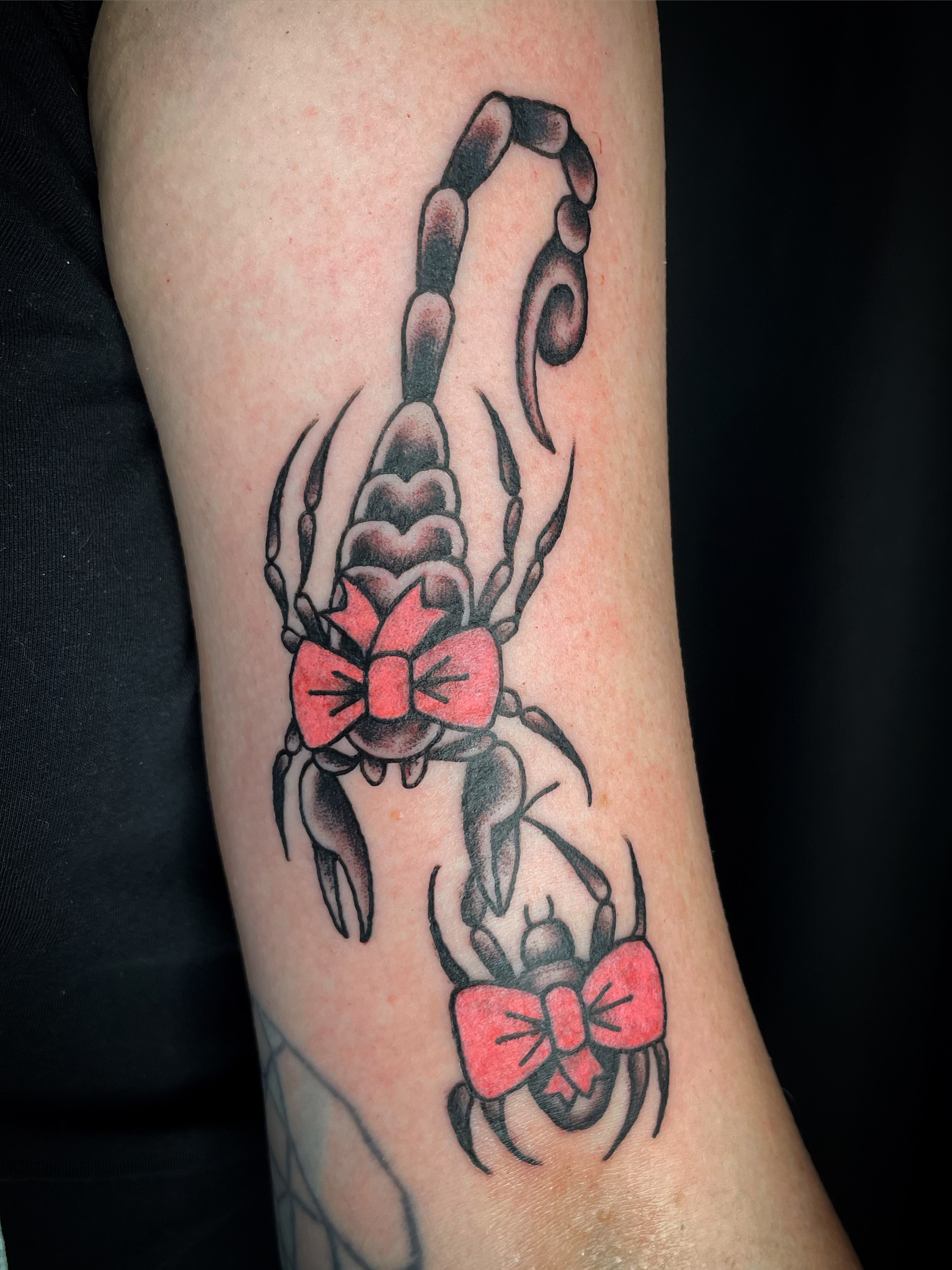 Scorpion with bow American traditional tattoo on the forearm by Nick Wallin