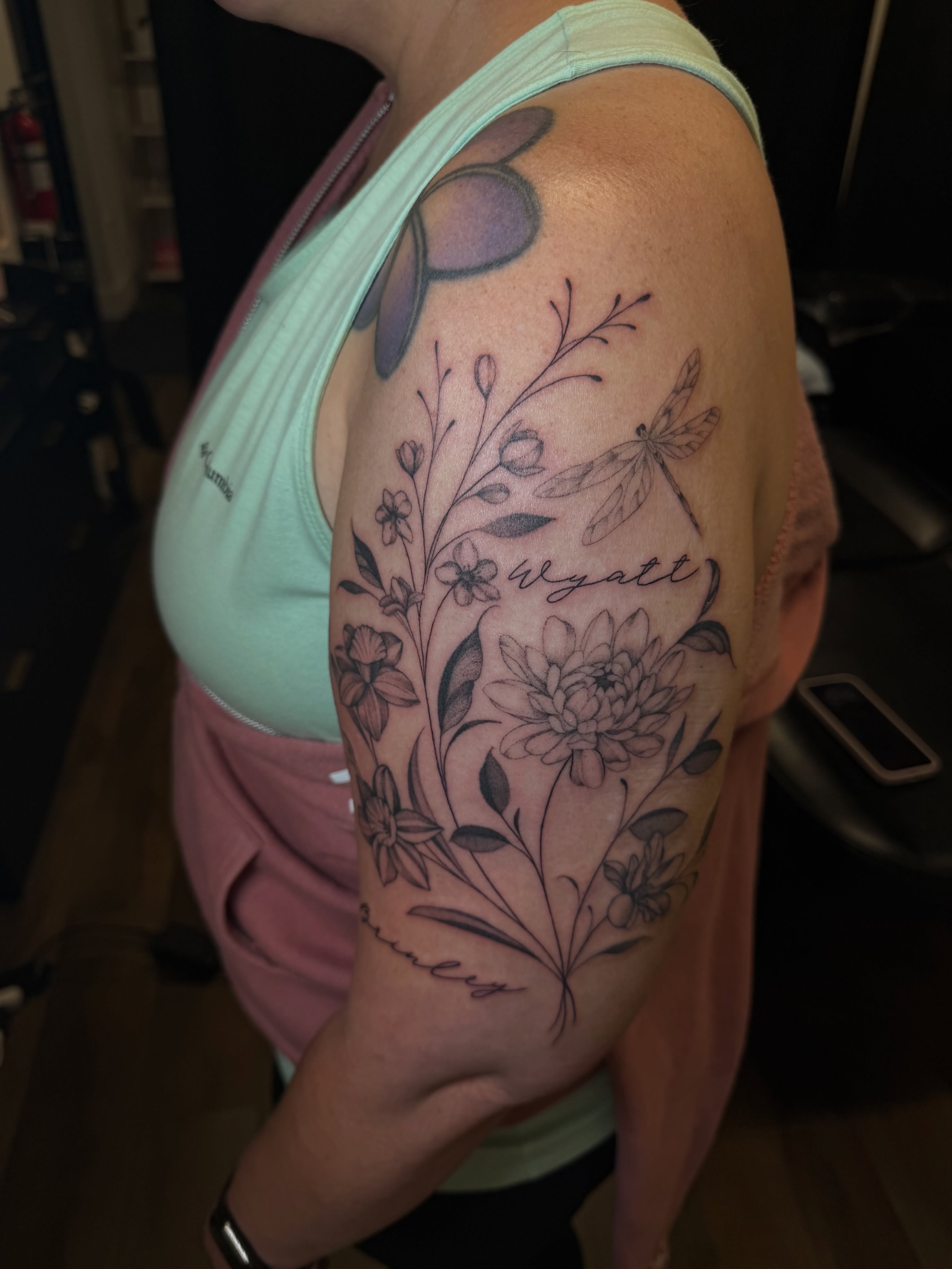 Floral arrangement black and grey tattoo on the shoulder by Priscilla Michels