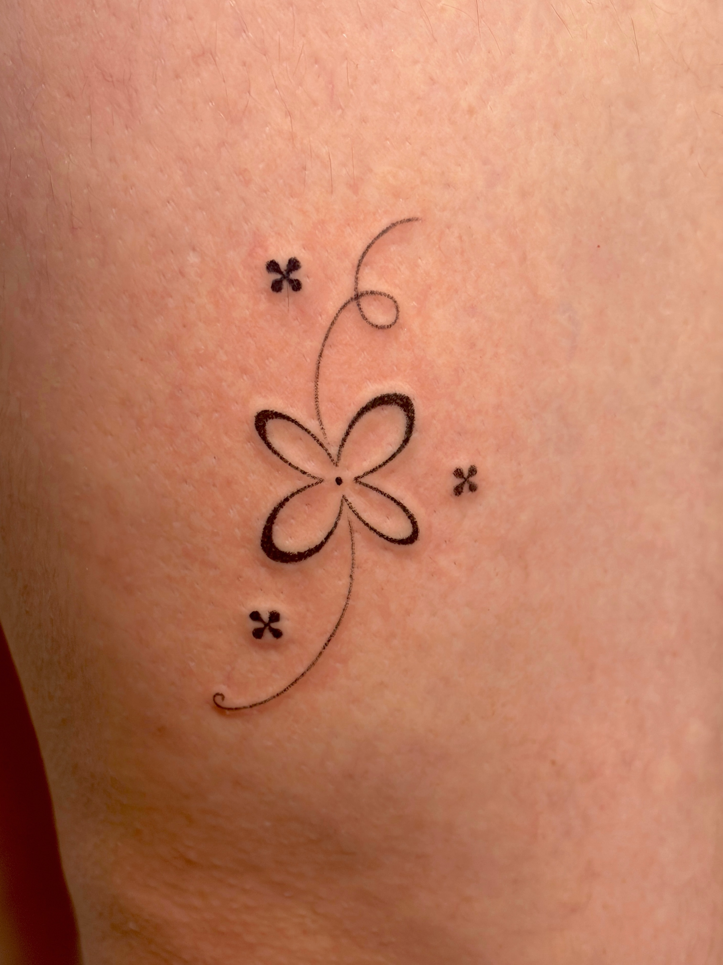 Flower fine line tattoo on the thigh by alli ミ☆
