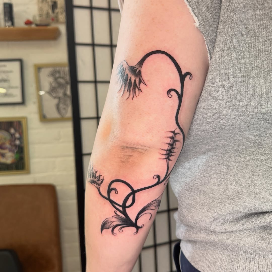 Floral vine black and grey tattoo on the forearm by Zac Smith-Chevalier