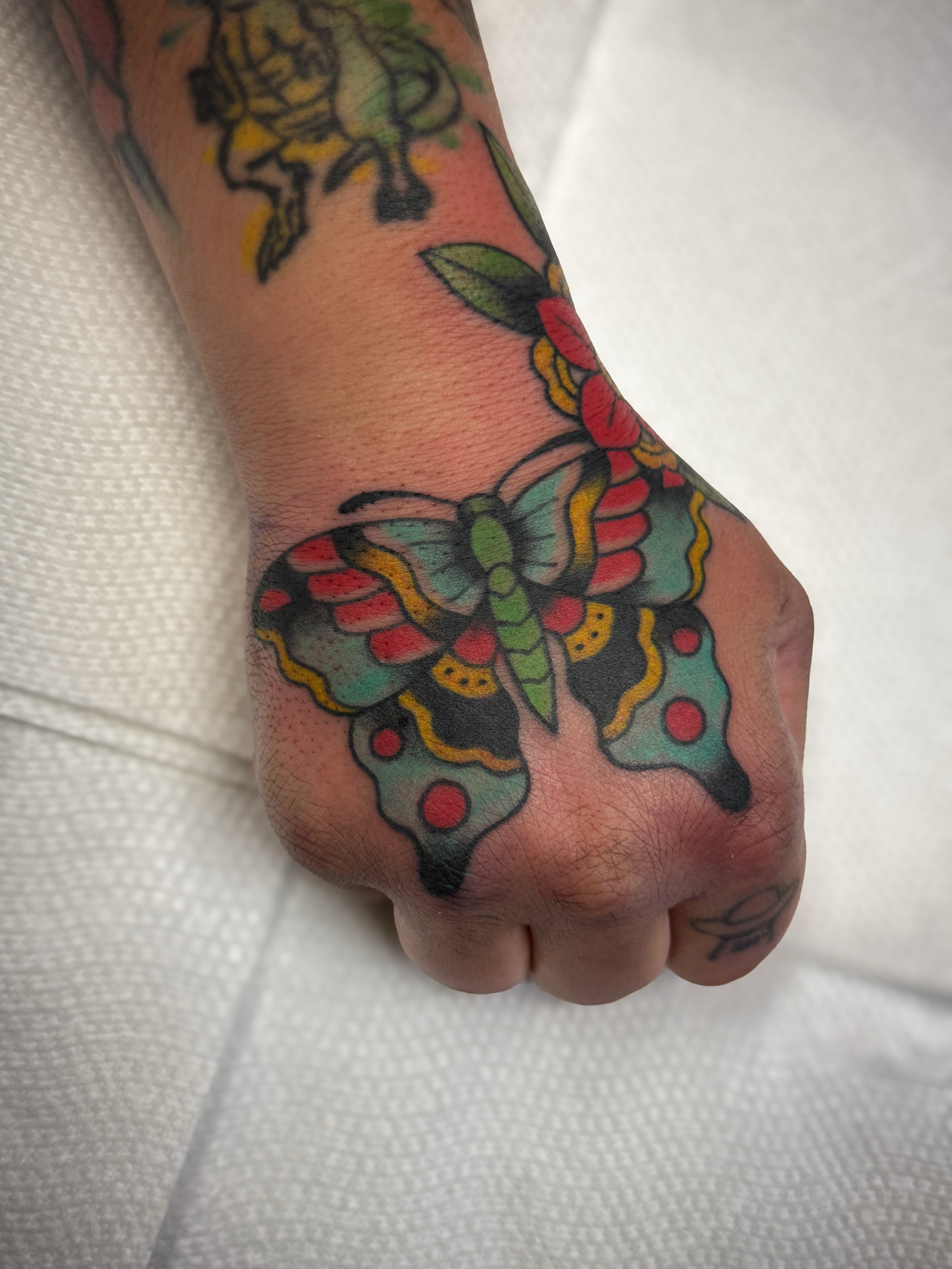 Butterfly American traditional tattoo on the foot by Jeremy Utley