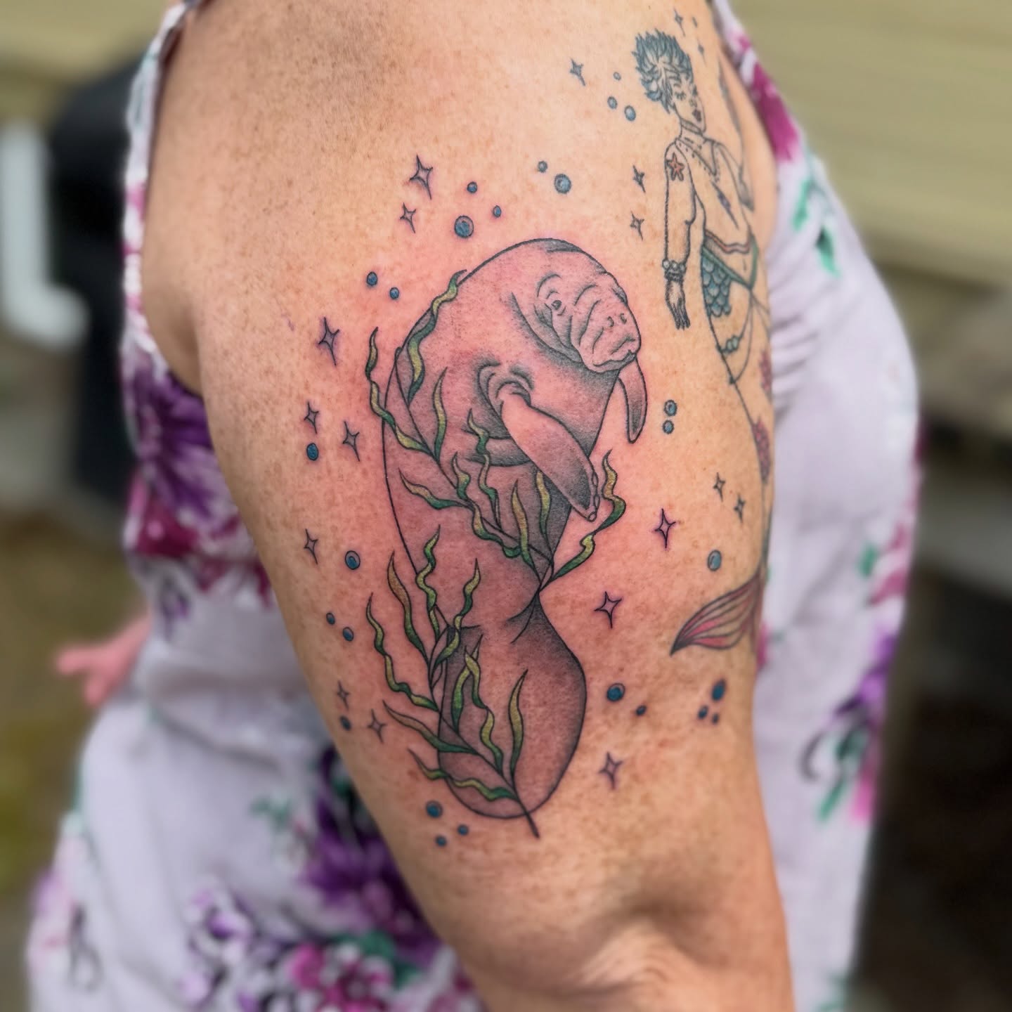 Manatee dotwork tattoo on the upper arm by Jenna Nicole