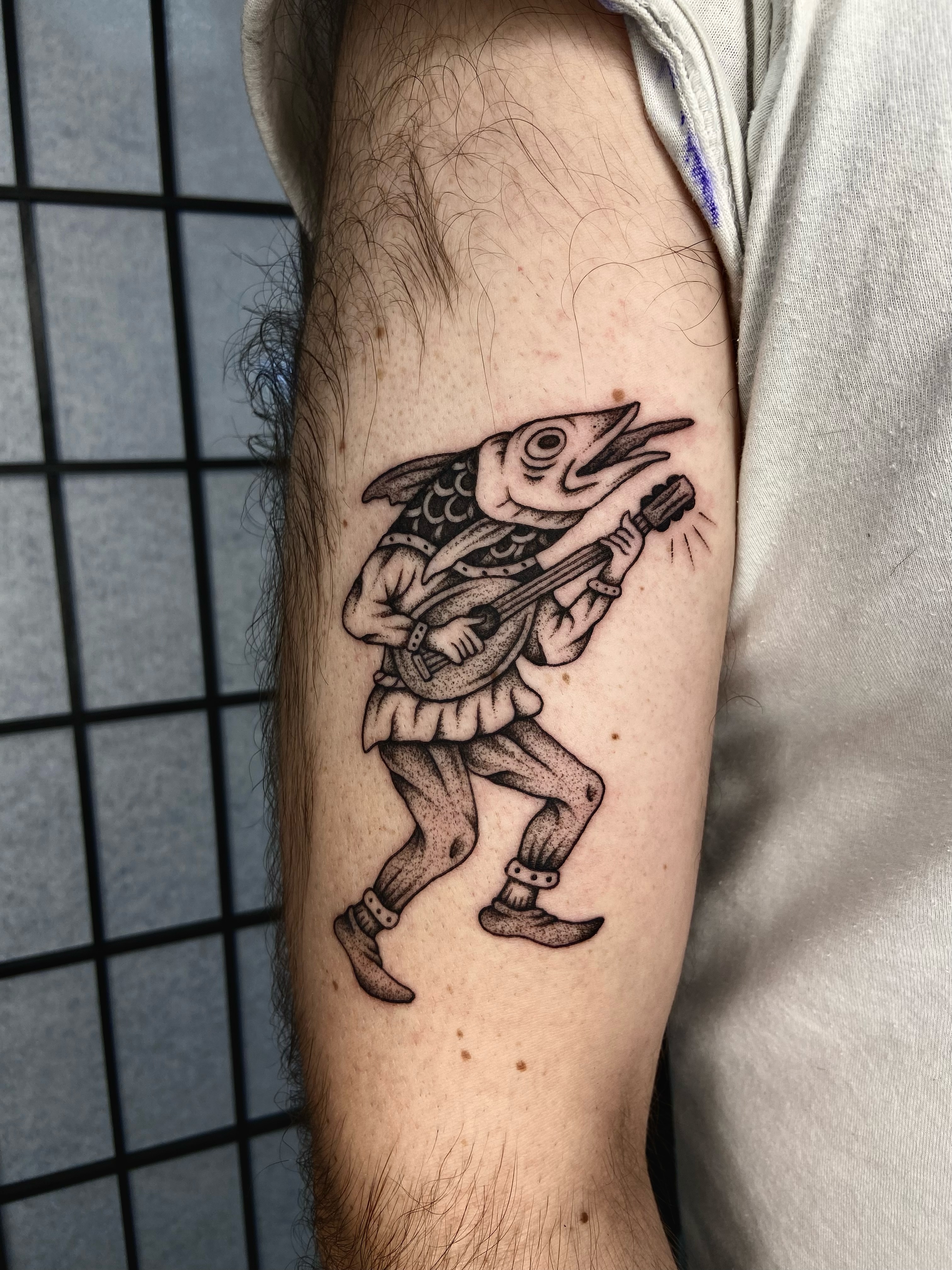 Fish playing guitar dotwork tattoo on the forearm by R y a n S m i t h