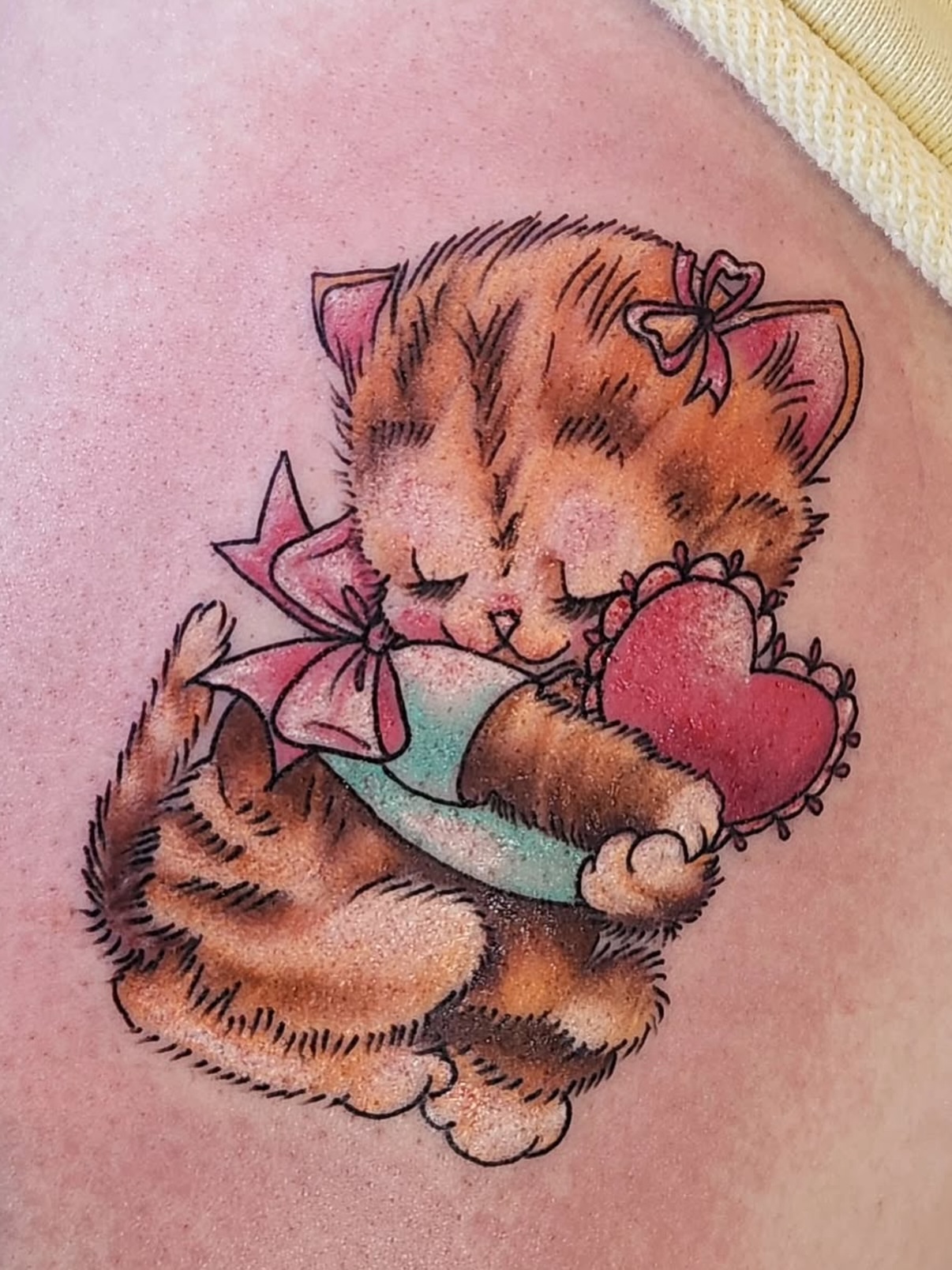 Sleeping kitten illustrative tattoo on the thigh by Heather