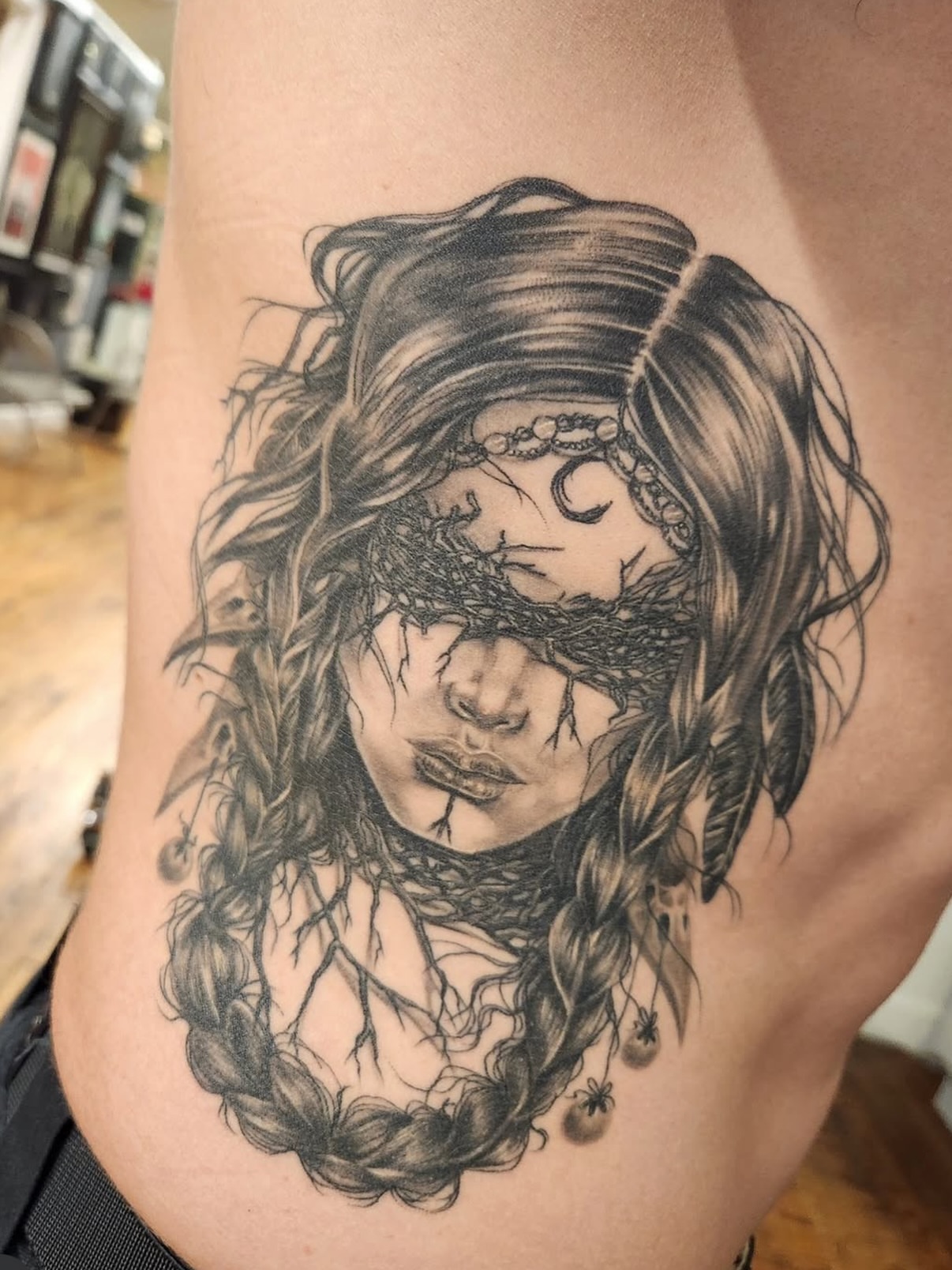 Woman with braids realism tattoo on the ribs by Heather