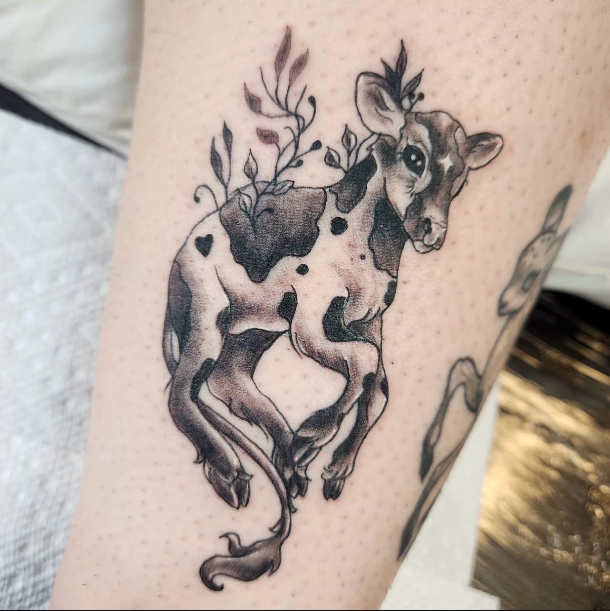 Cow black and grey tattoo on the forearm by Heather