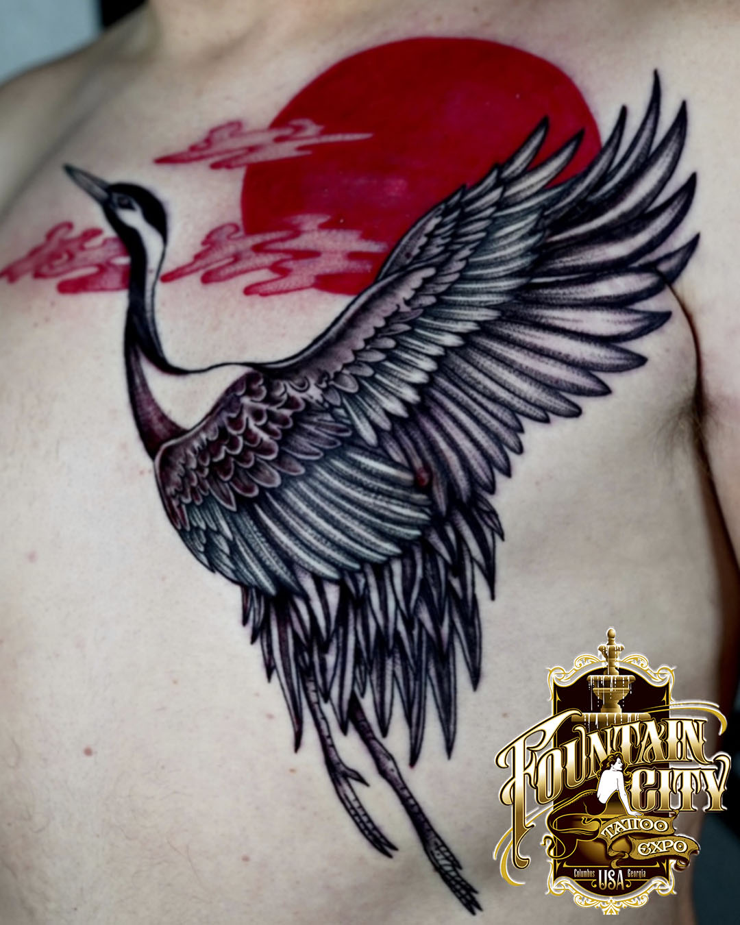 Crane and sun black and grey tattoo on the chest by Kirsten Cameron