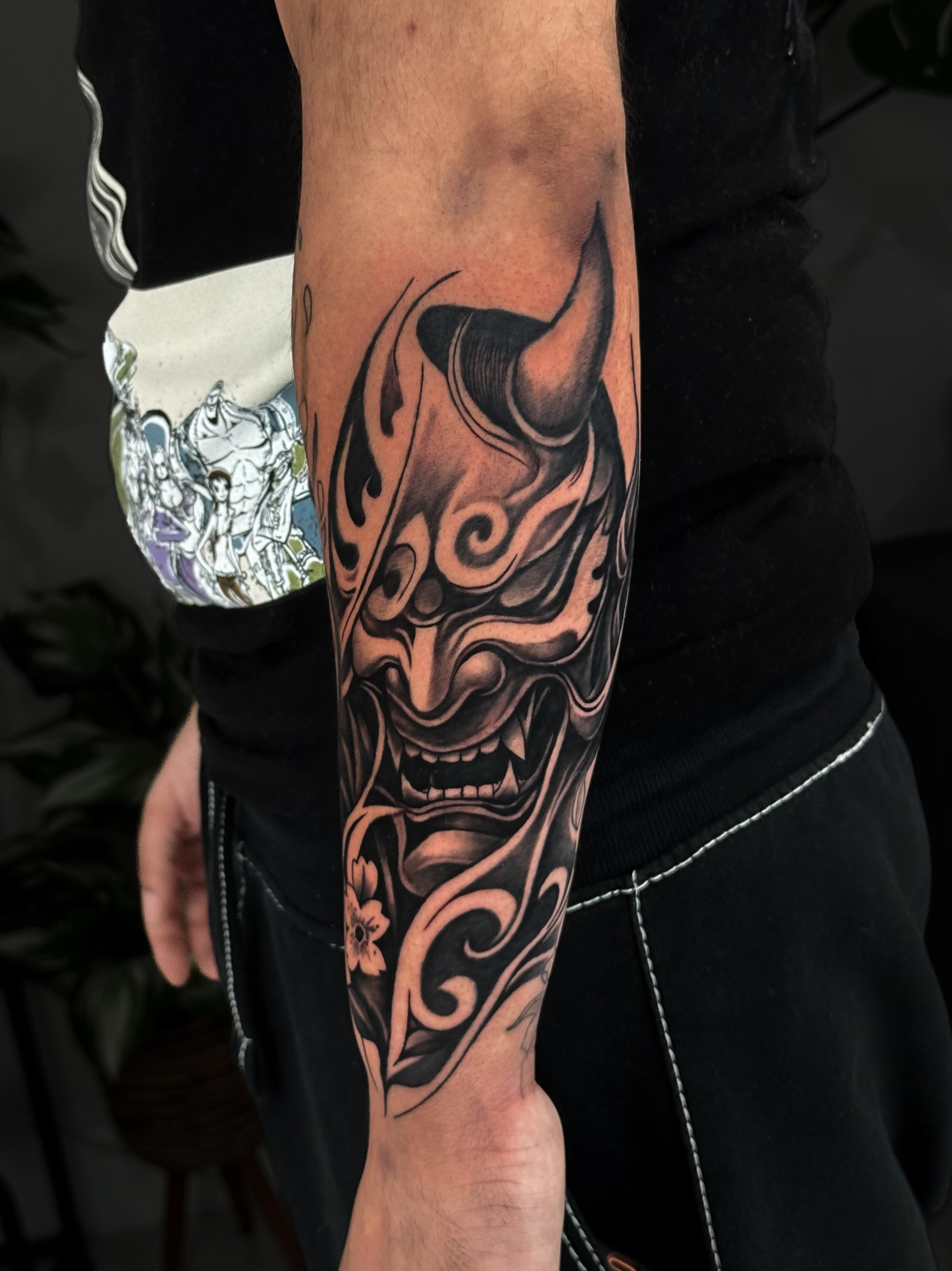 Mask tribal tattoo on the forearm by Kai, Charlotte, North Carolina