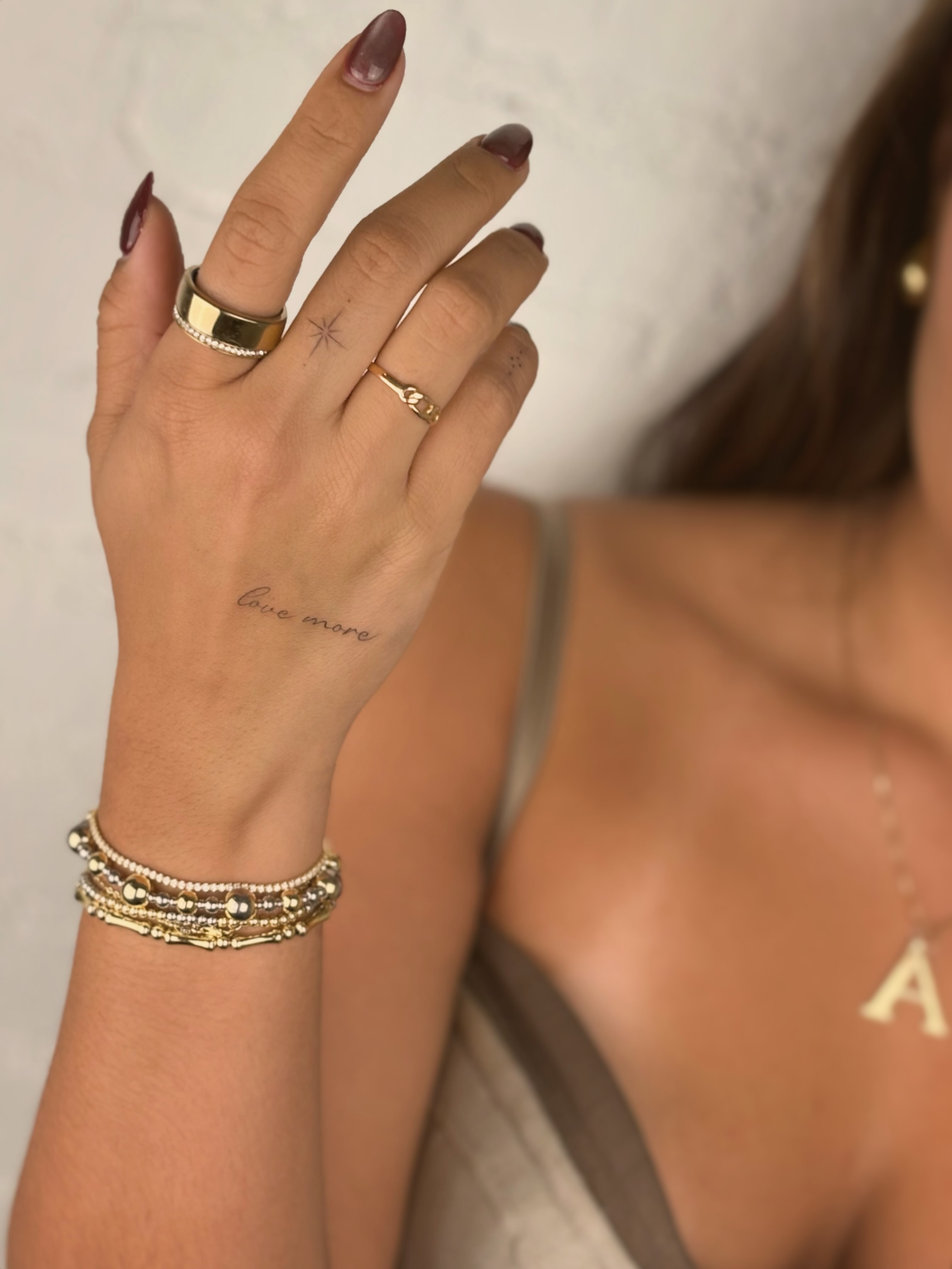 Love more lettering script tattoo on the hand by Christopher Vasquez