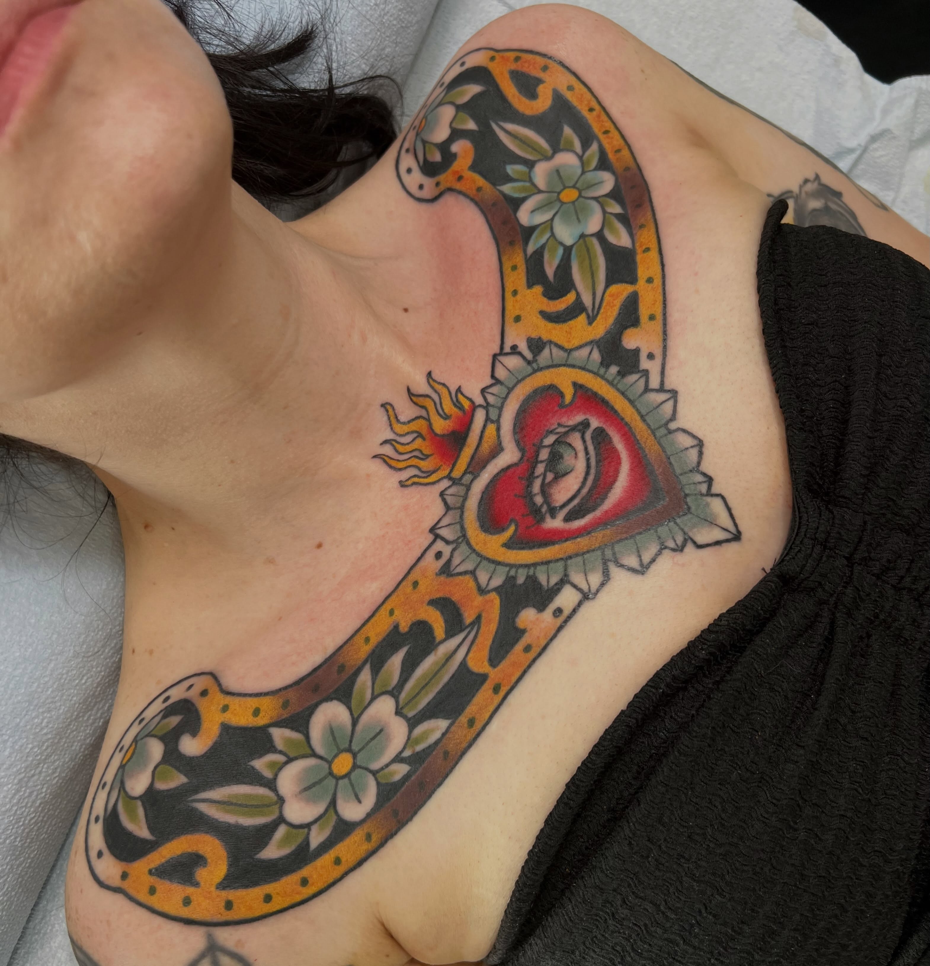 Heart with eye American traditional tattoo on the chest by Kyle Olson, Salt Lake City, Utah