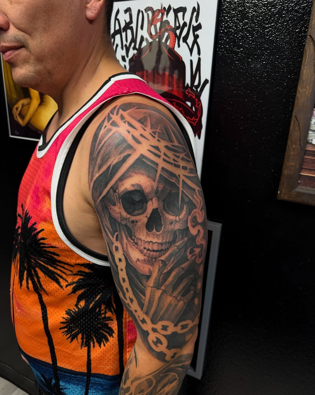 Skull with barbed wire realism tattoo on the upper arm by Amber Lynn
