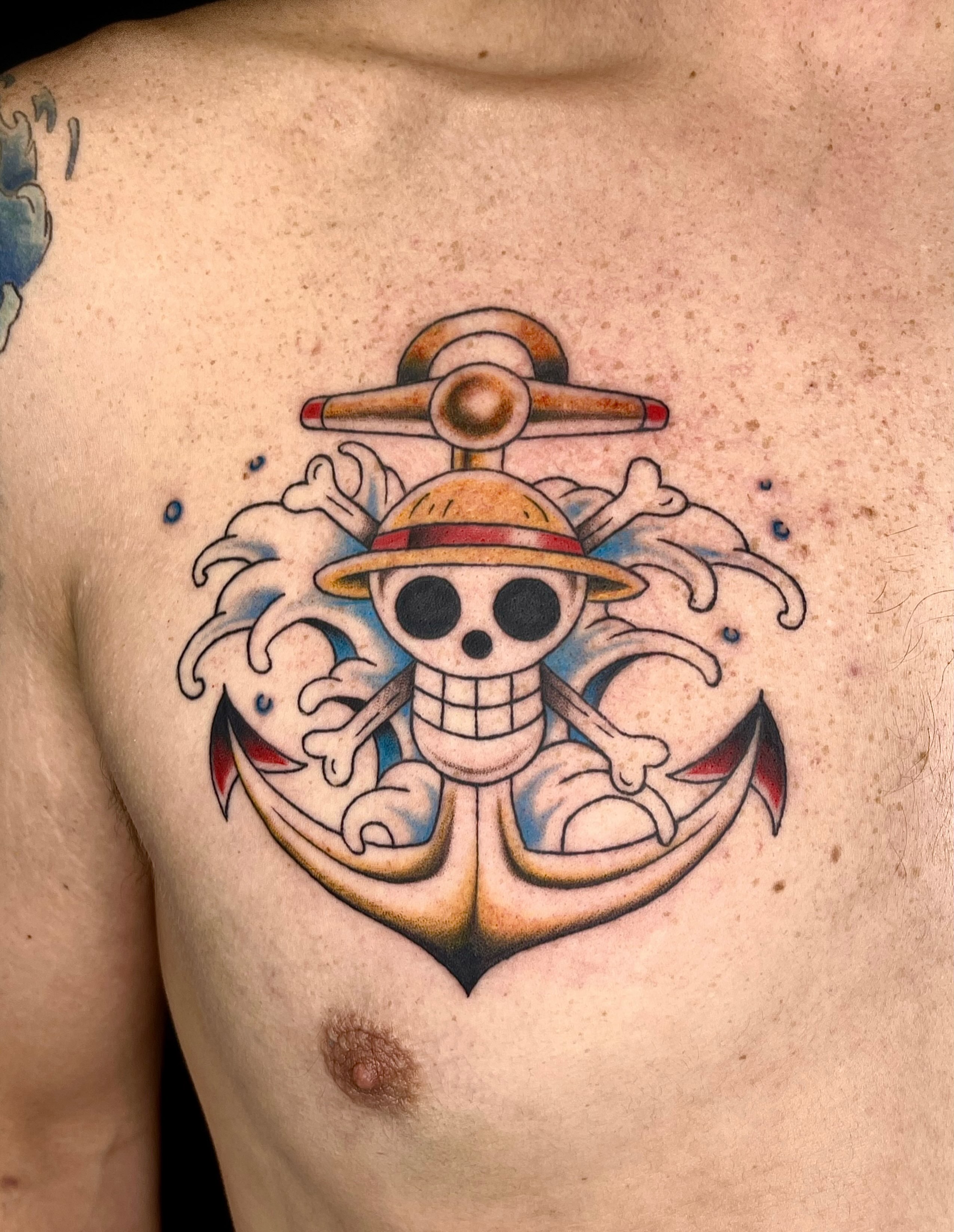 Skull with straw hat anime tattoo on the chest by Chase Healey, Salt Lake City, Utah