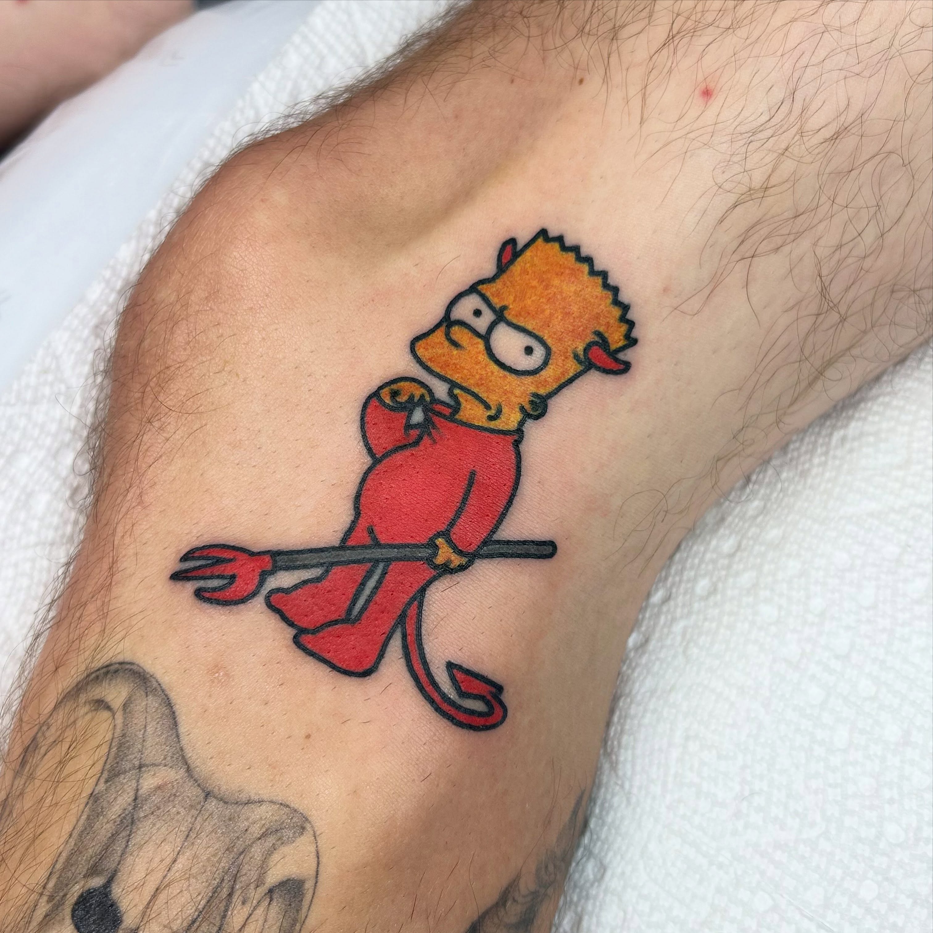 Bart Simpson as devil new school tattoo on the forearm by Stephen Sanchez