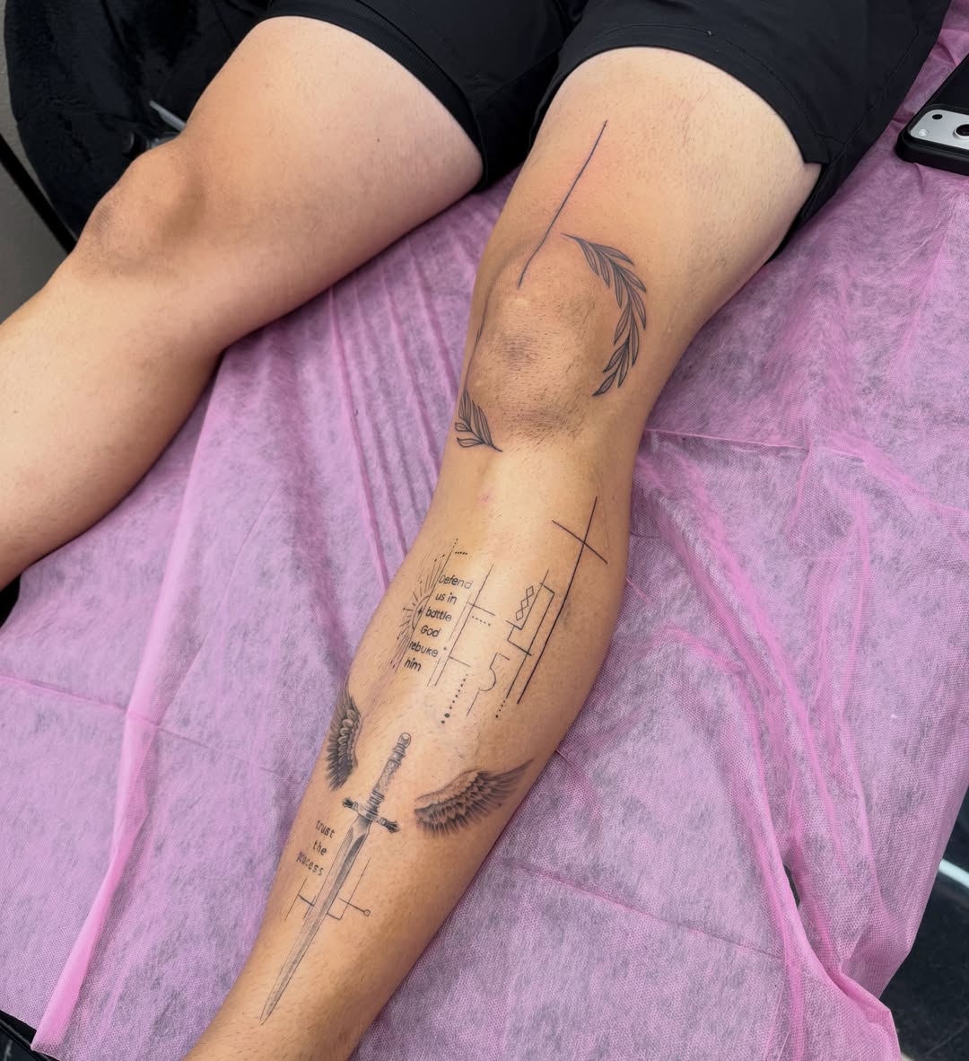 Sword and wings black and grey tattoo on the forearm by Amber Lynn