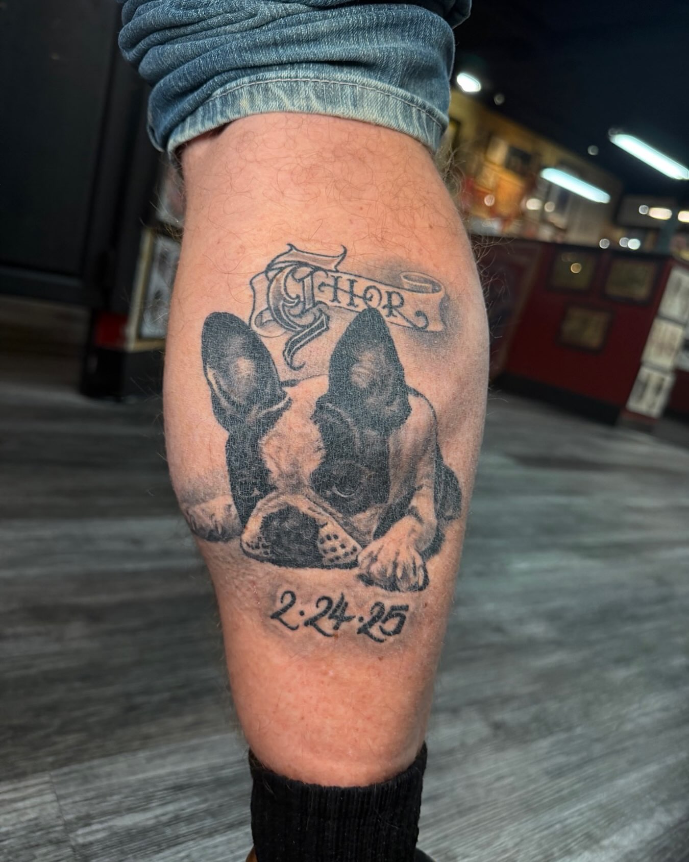 Dog black and grey tattoo on the forearm by Skoty Fox