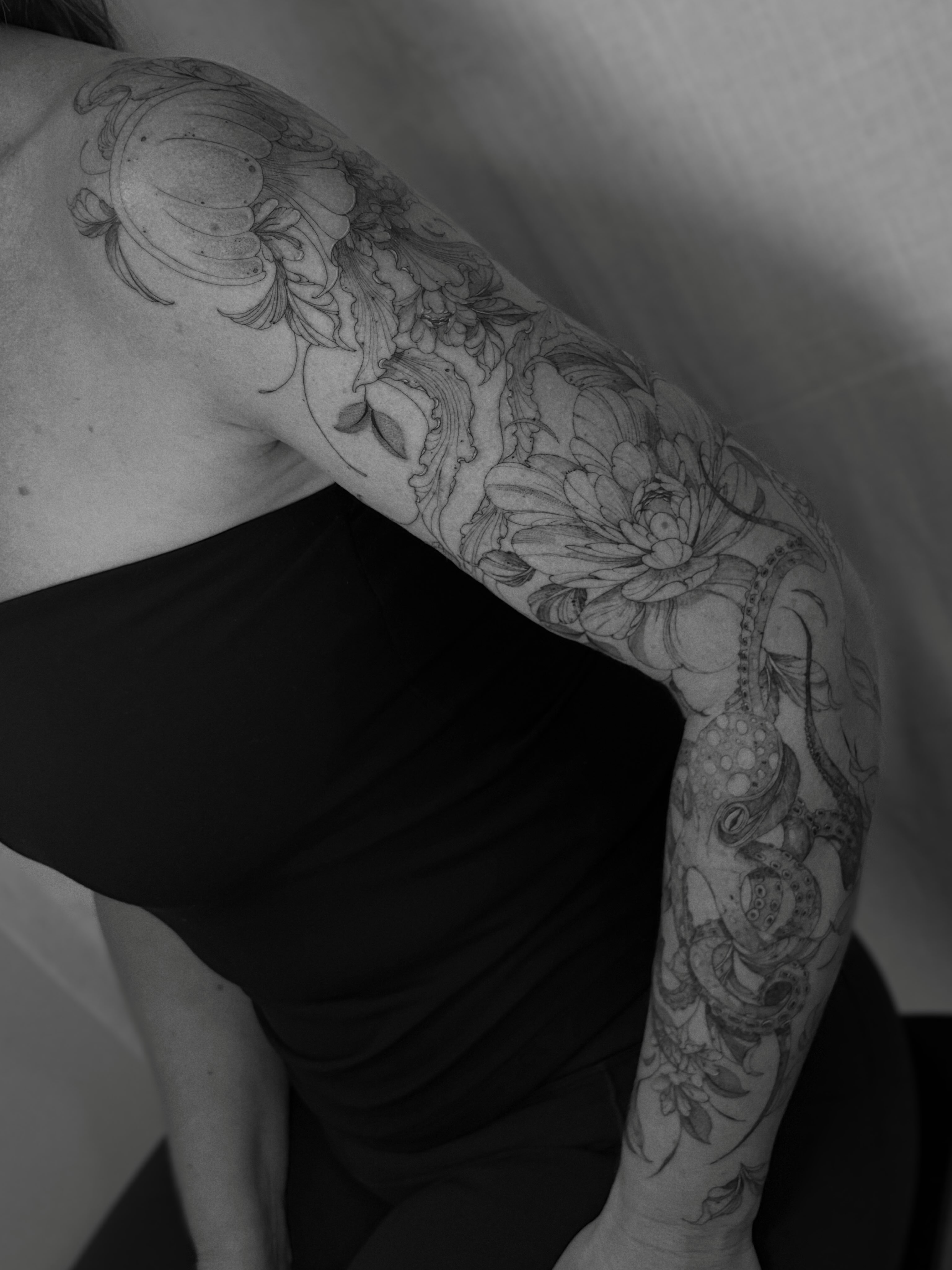 Floral and octopus realism tattoo on the upper arm by Justene Renee 🖤 Fine Line Tattoo Artist