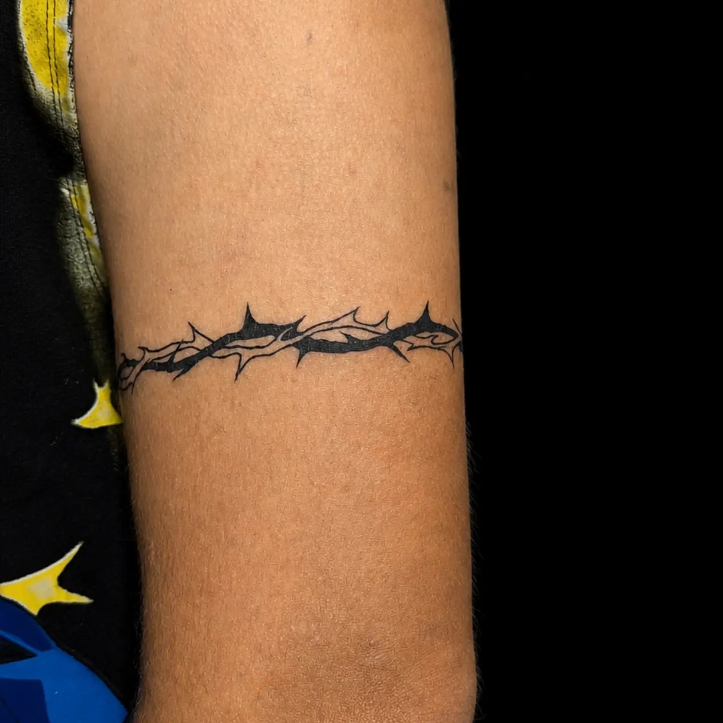 Thorn crown black and grey tattoo on the forearm by Tony