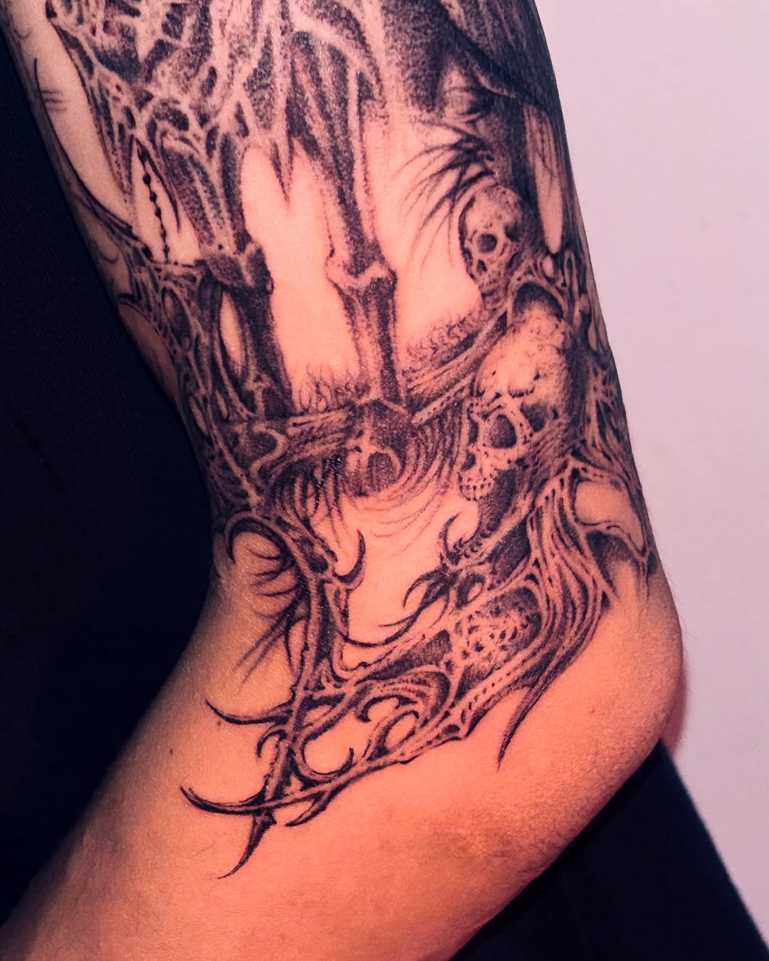 Skull and bones black and grey tattoo on the forearm by LX7