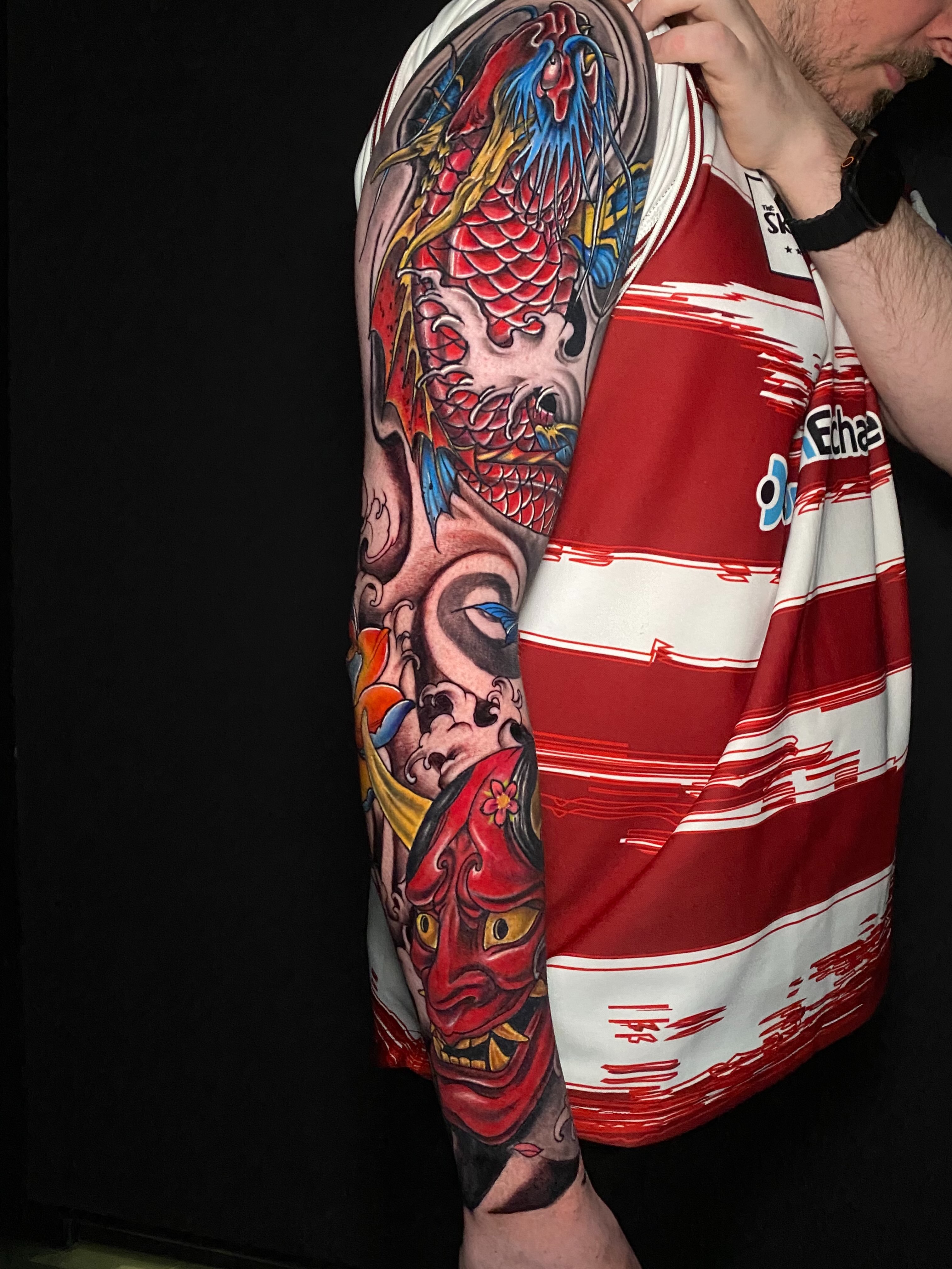 Koi fish and mask japanese irezumi tattoo on the upper arm by @dom_macio_tattoo